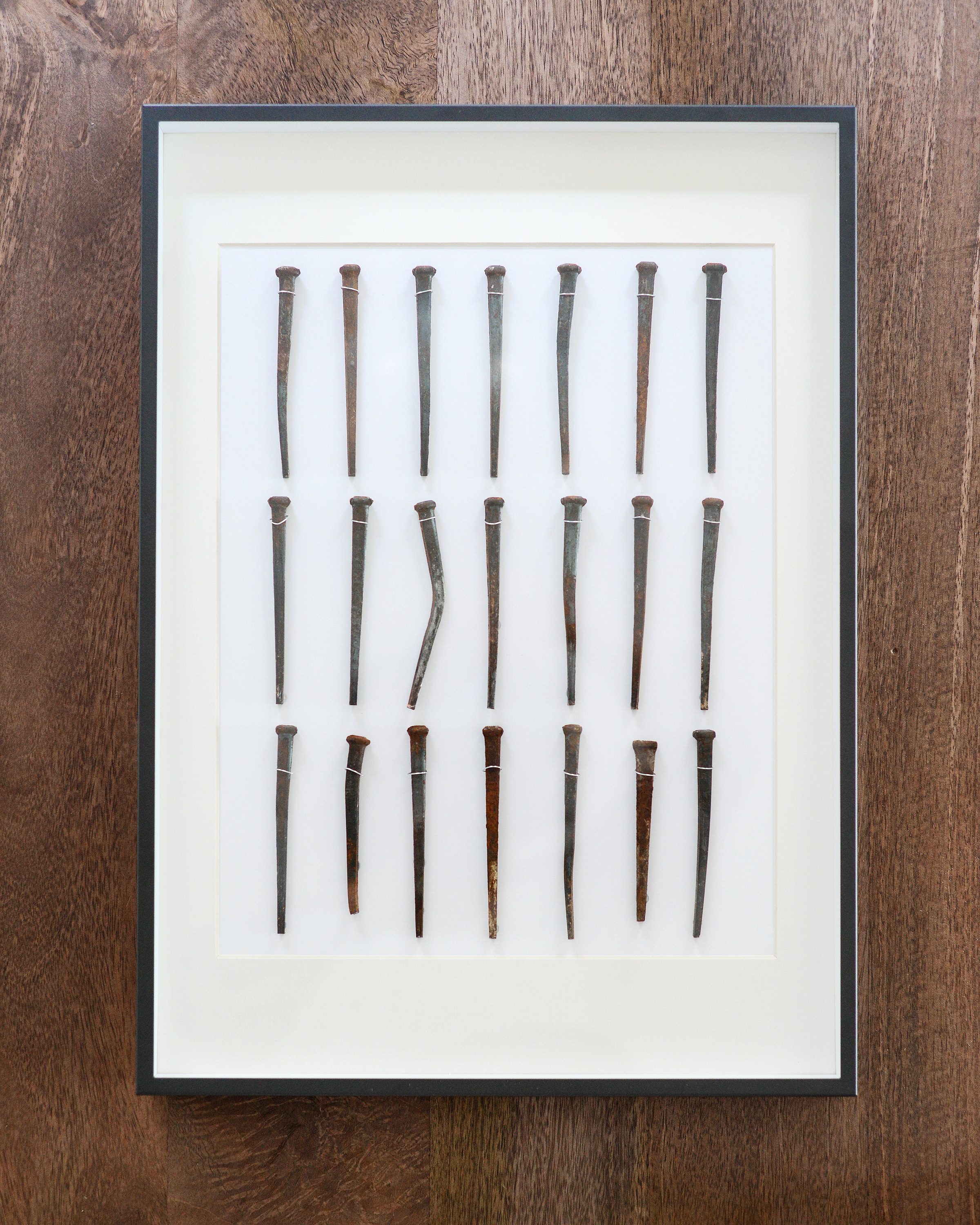 A shadow box frame using old nails from a home renovation | via Yellow Brick Home