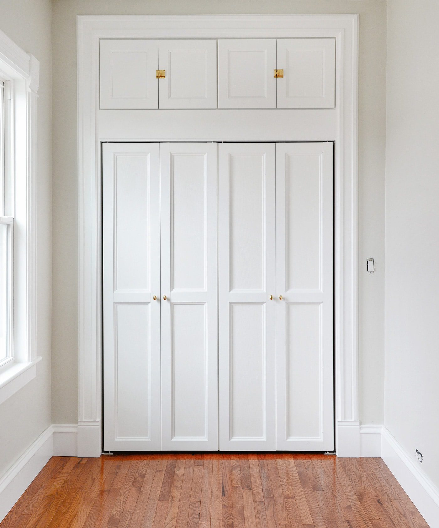 wide view of custom molding on bi-fold doors | via Yellow Brick Home