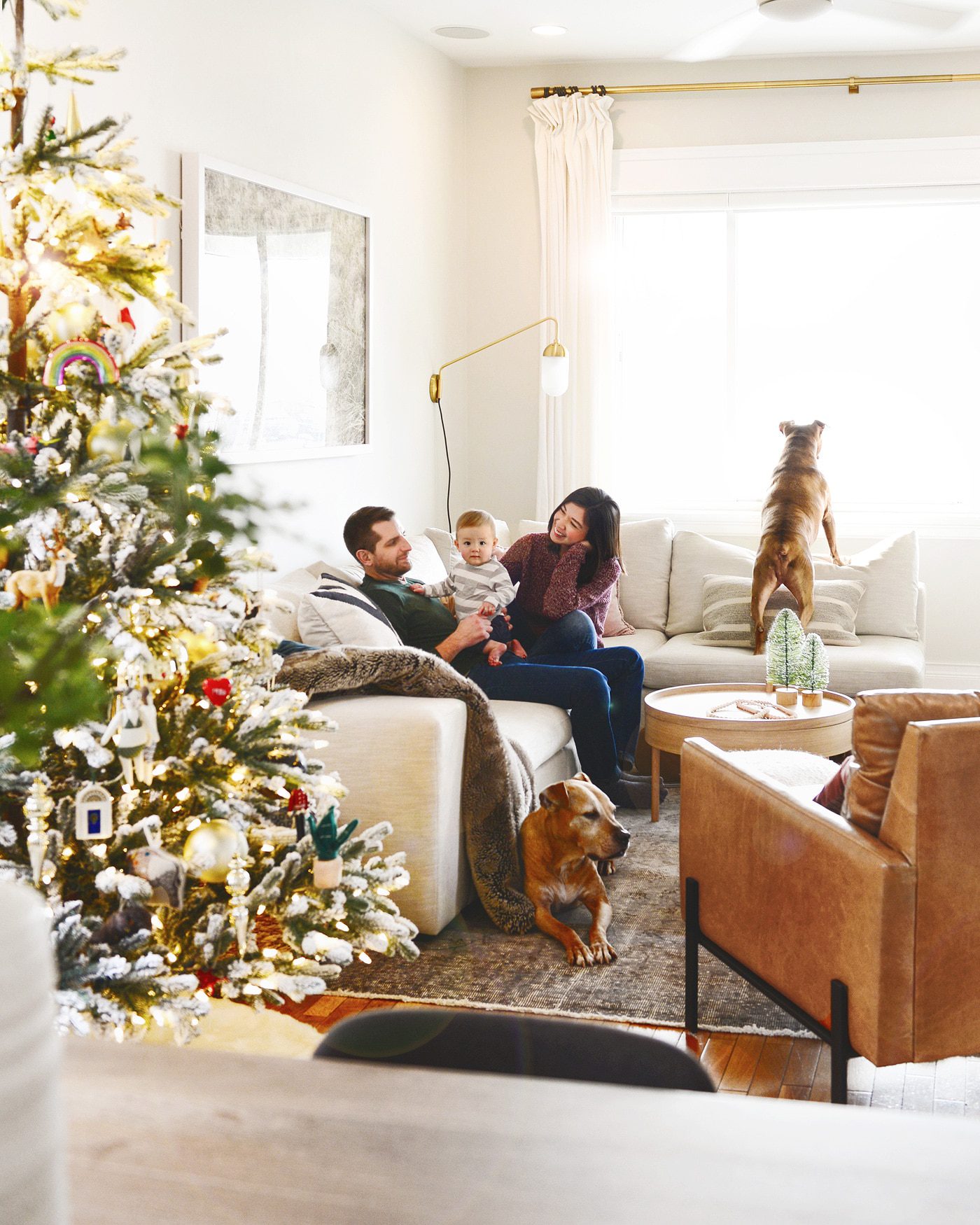 Merry Christmas! Happy Holidays! Neutral holiday living room with flocked Christmas tree // via Yellow Brick Home