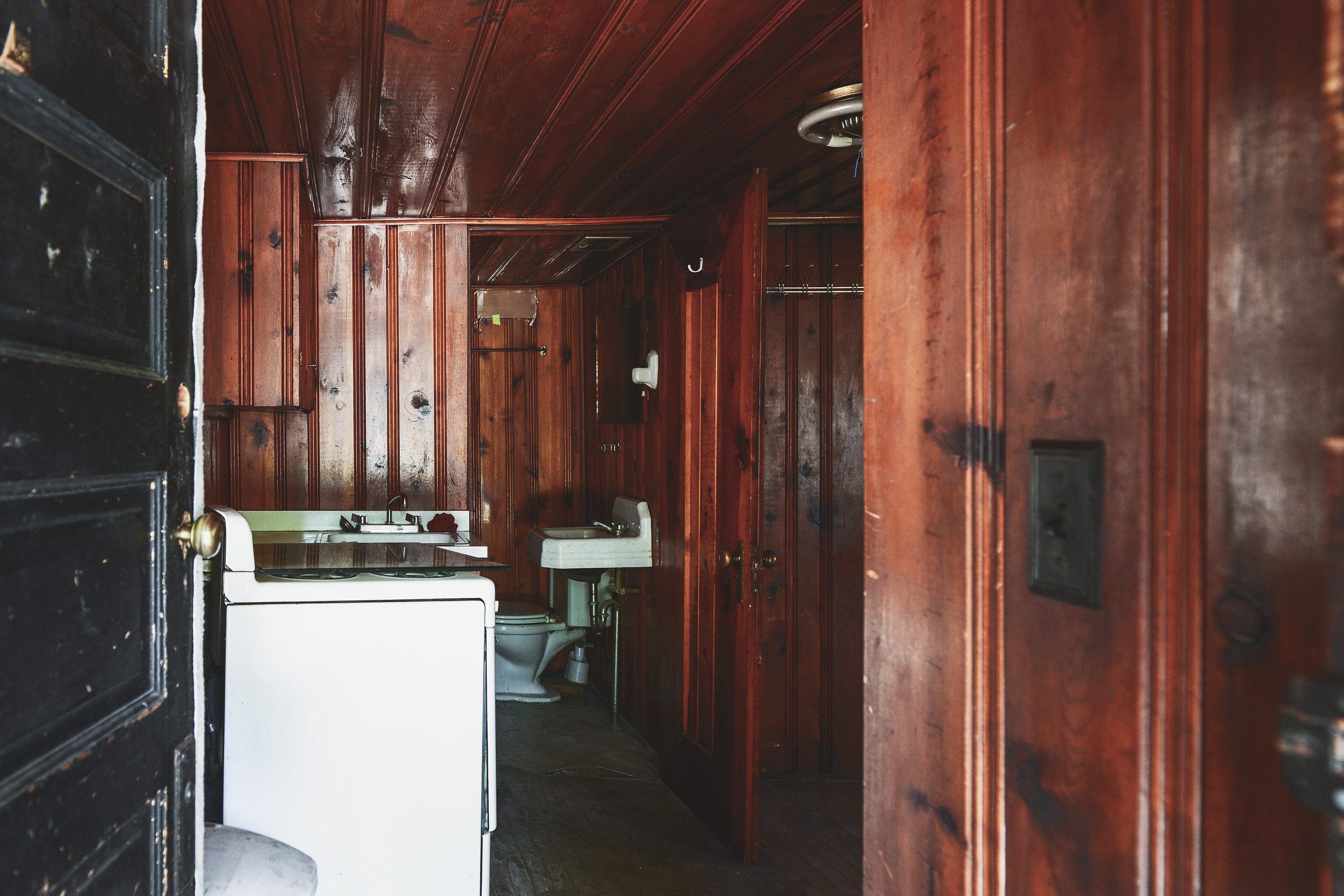 a dated bathroom with wood paneling | Two Flat den bathroom before + after! | via Yellow Brick Home