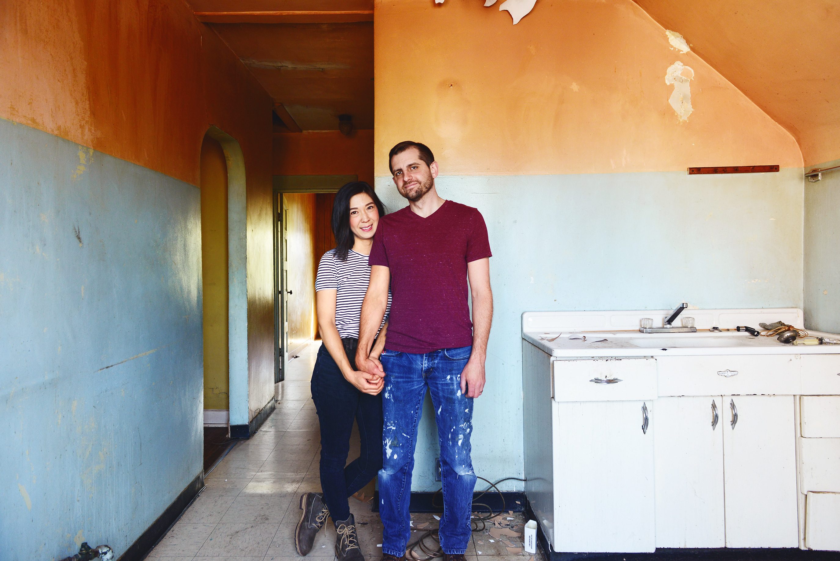Scott and Kim standing in the Two Flat kitchen before it's renovated | Our goals for 2020, the best is yet to come! via Yellow Brick Home