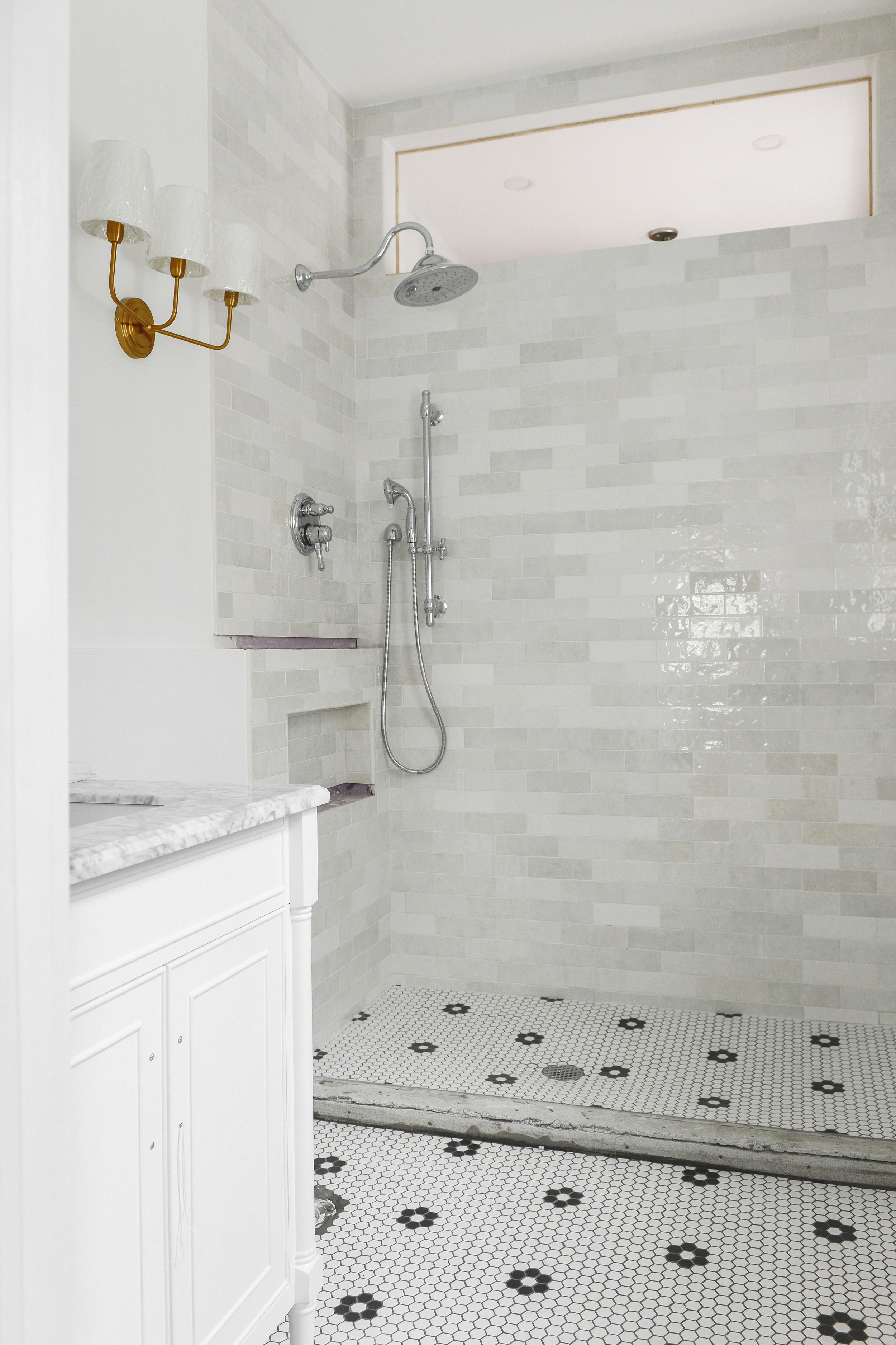Our bathroom renovation update, which includes brass fixtures and hex tile with rosettes | via Yellow Brick Home