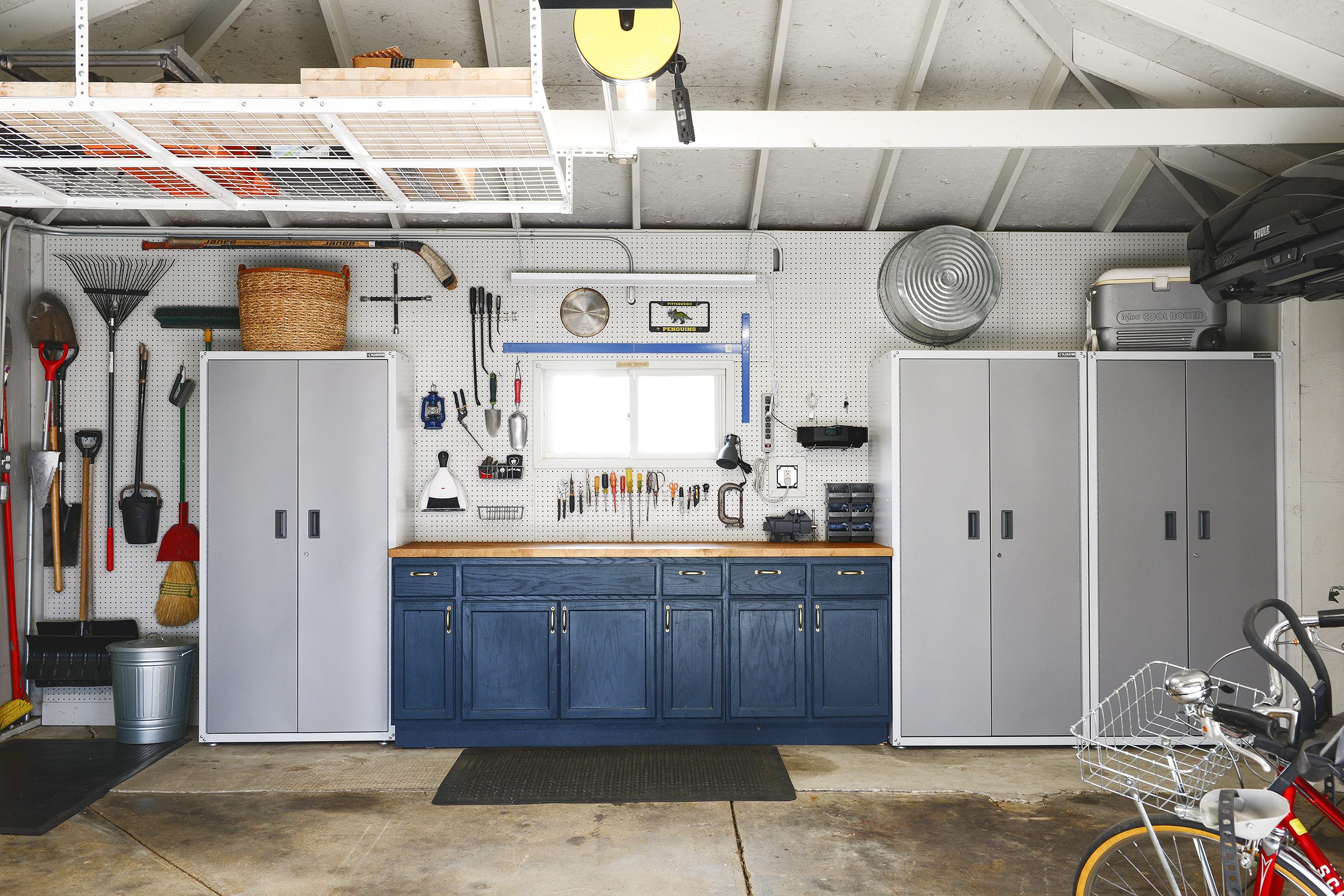 A navy blue garage // 7 Garage Organization Tips Before Winter Hits! via Yellow Brick Home with Lowe's Home Improvement #lowespartner