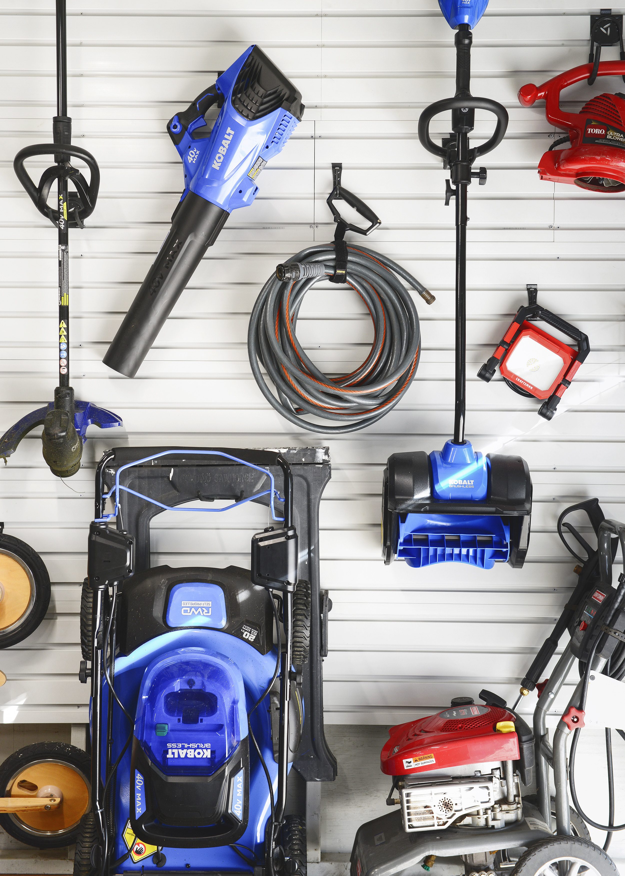 A wall of Gladiator Gear Wall with tools hanging from it // 7 Garage Organization Tips Before Winter Hits! via Yellow Brick Home with Lowe's Home Improvement #lowespartner