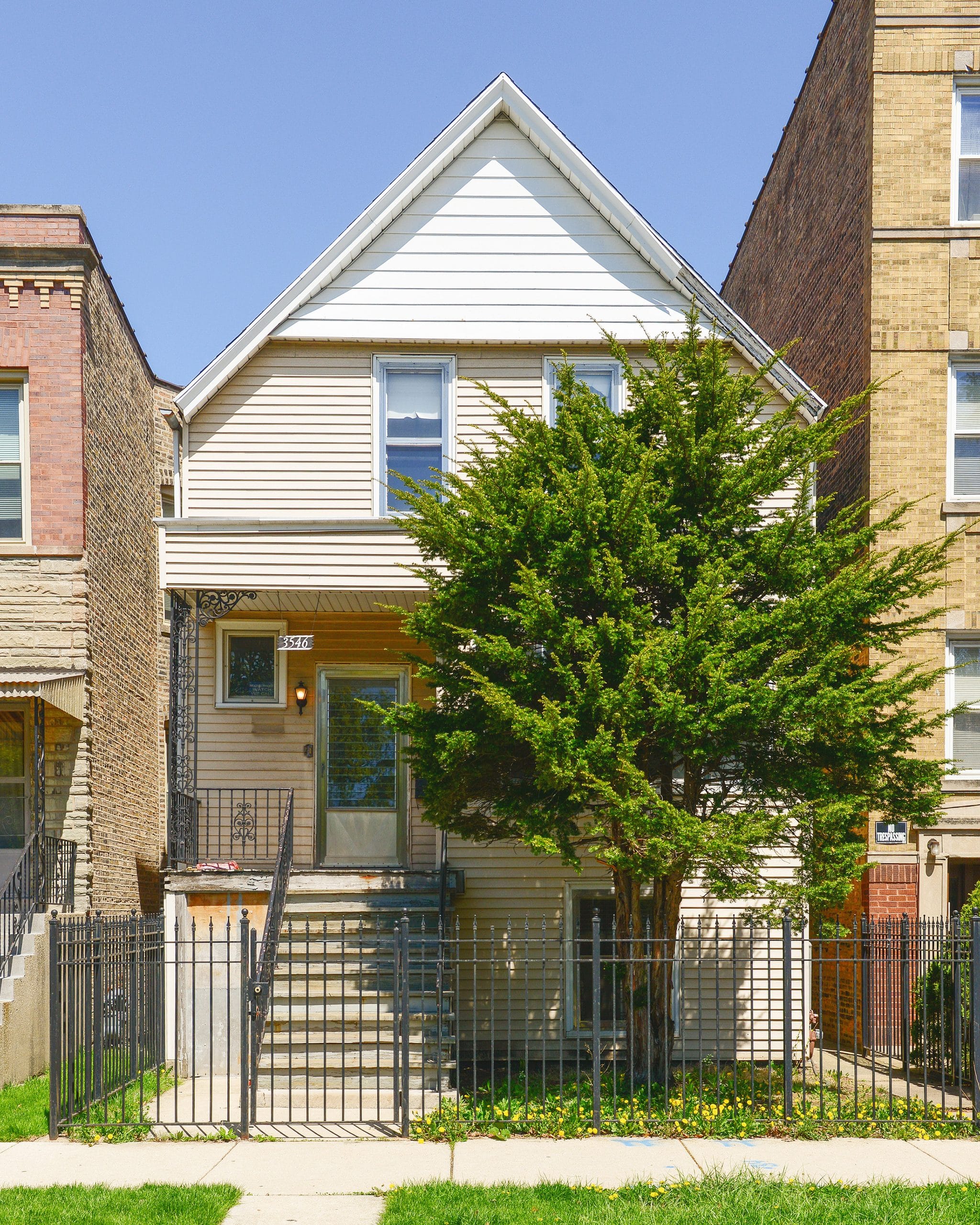 An overgrown tree blocks the front of a chicago two flat // via Yellow Brick Home