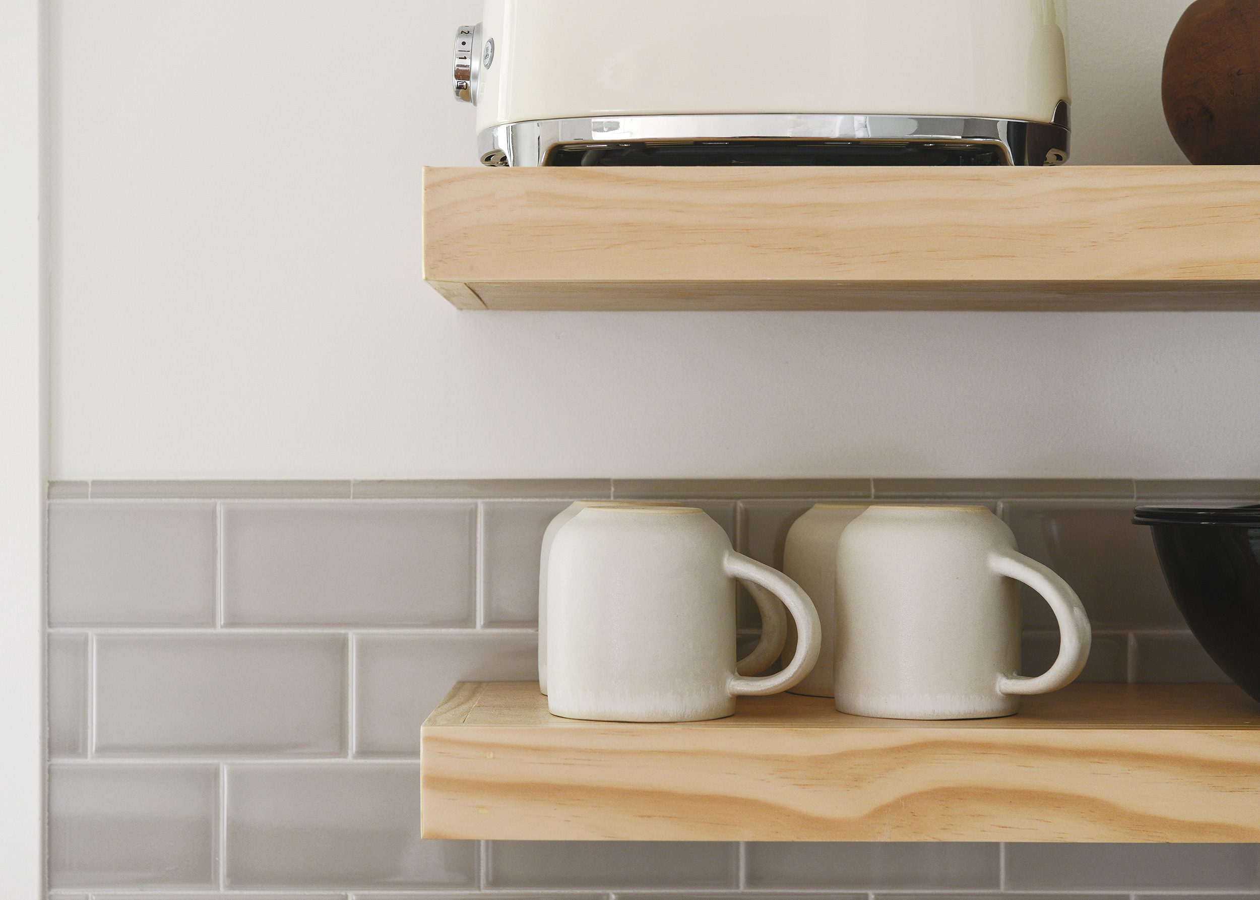 coffee mugs styled on an open shelf in the kitchen // Is open shelving in a kitchen the right choice for you? I'm sharing my tips for design + practicality, plus the one thing I'd do differently. | via Yellow Brick Home