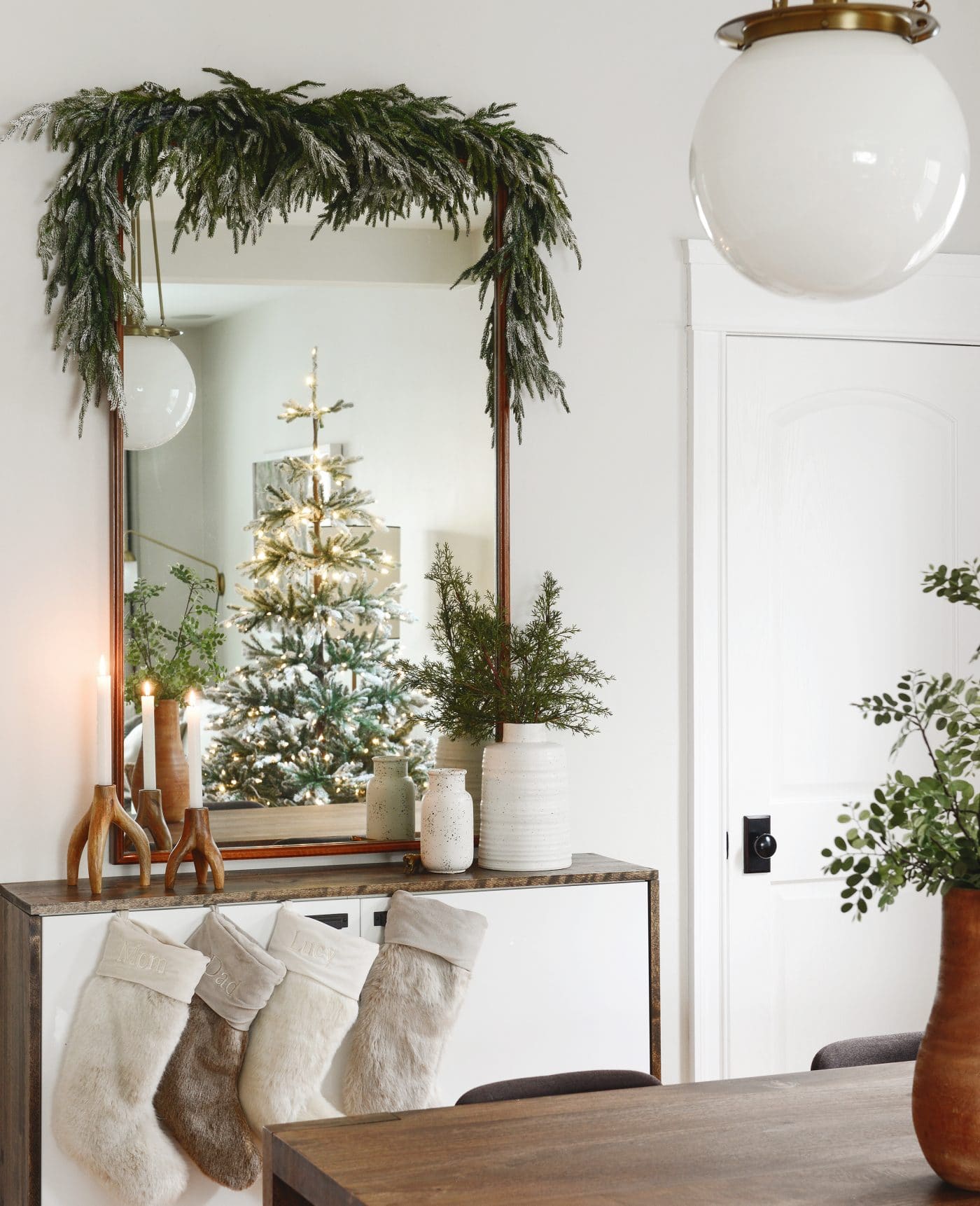 Living and dining room view with faux greenery | Which flocking spray is best? | How to flock your own holiday garland, tree and decor, via Yellow Brick Home
