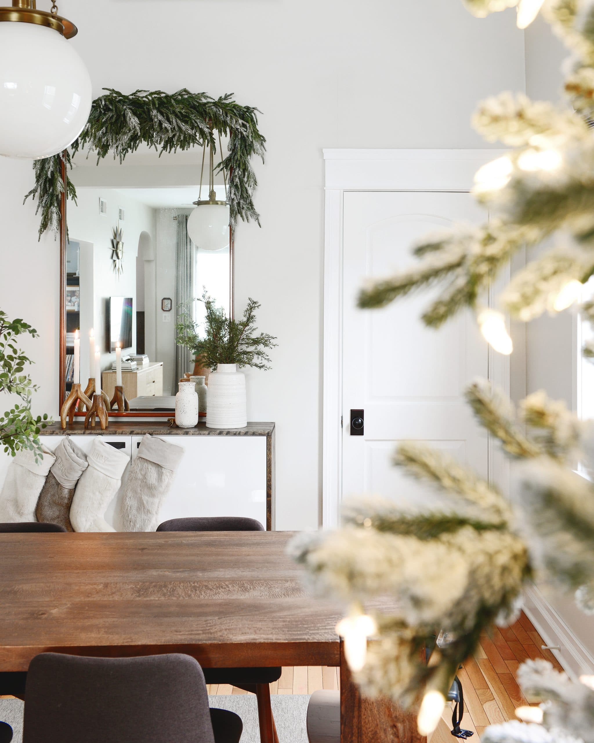 Living and dining room view with faux greenery | Which flocking spray is best? | How to flock your own holiday garland, tree and decor, via Yellow Brick Home