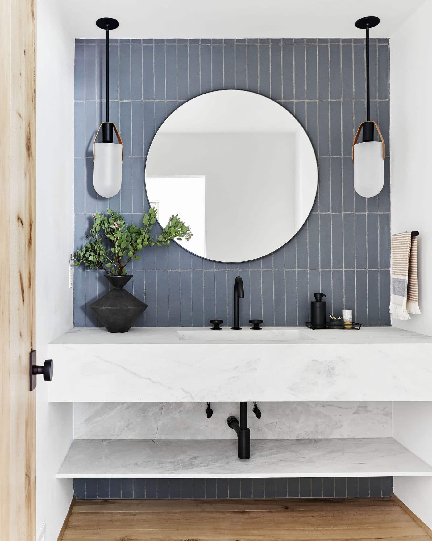 Bathroom with a wall-to-wall marble sink and blue tile with black fixtures | Inspiration for Stacked Tile, stacked bond tile pattern, via Yellow Brick Home