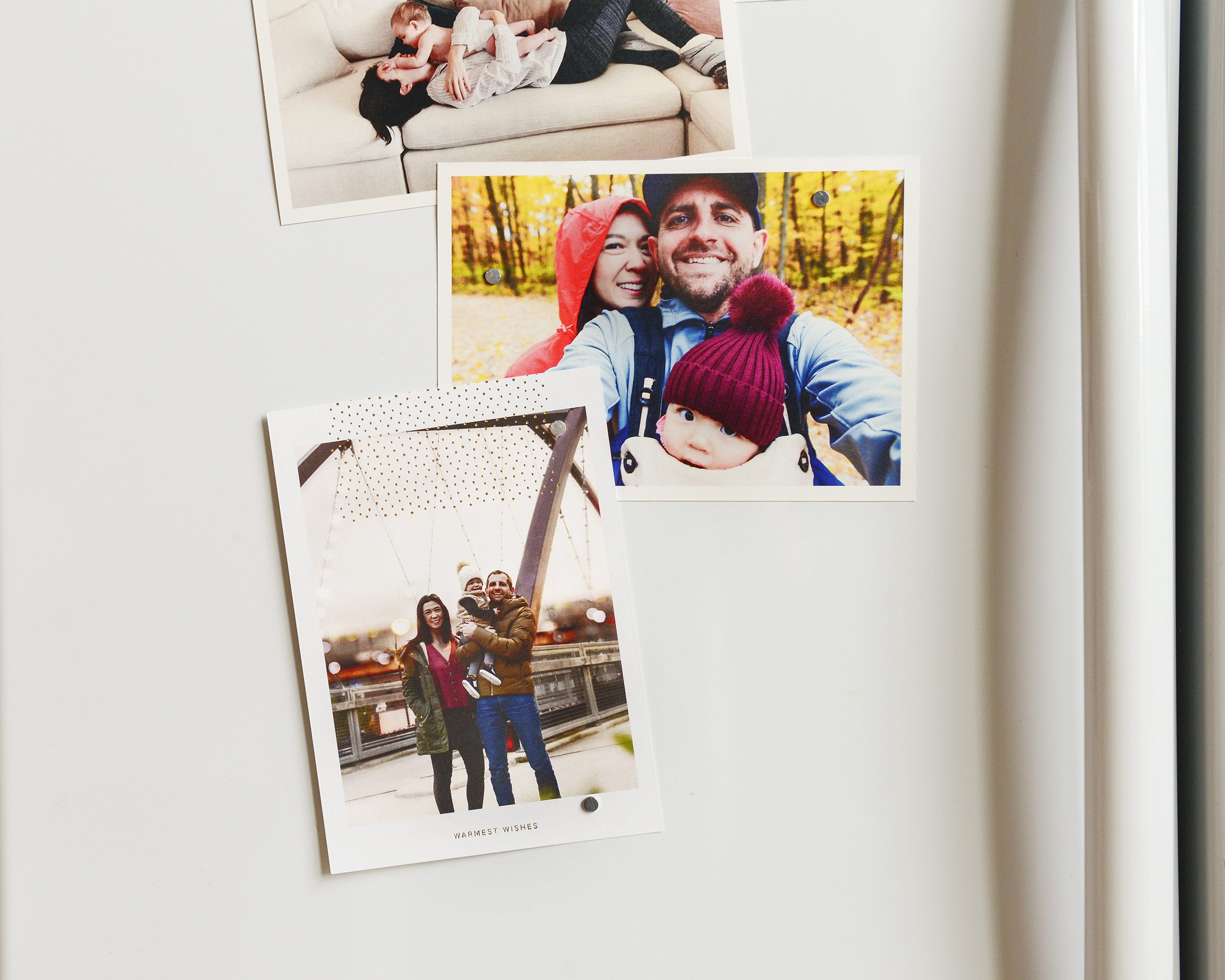 A photo of a Christmas card and family photos on the fridge | Our holiday cards with Artifact Uprising via Yellow Brick Home