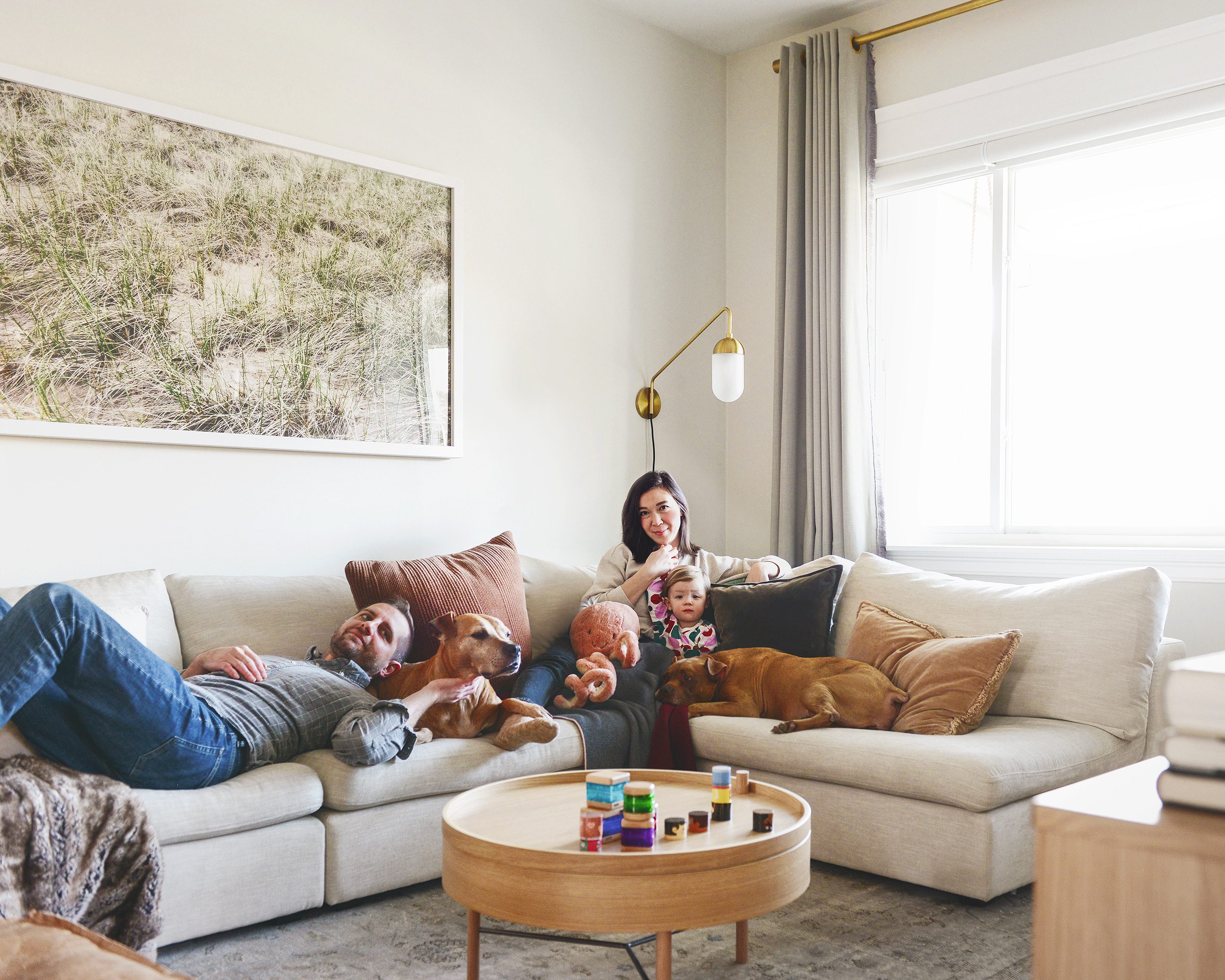 Our family + two Pit Bulls hanging out in our living room on the corner sectional | Our goals for 2020, the best is yet to come! via Yellow Brick Home