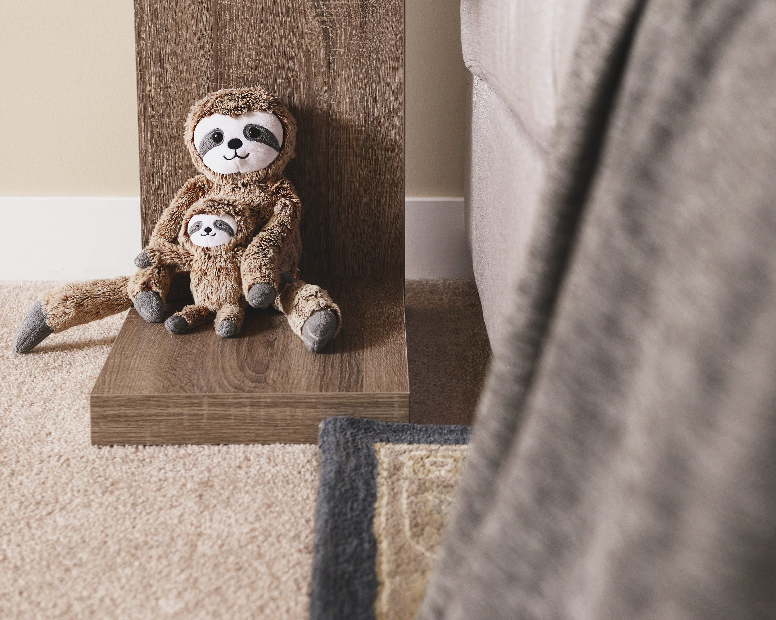 Sloth stuffie sitting on an end table | via Yellow Brick Home