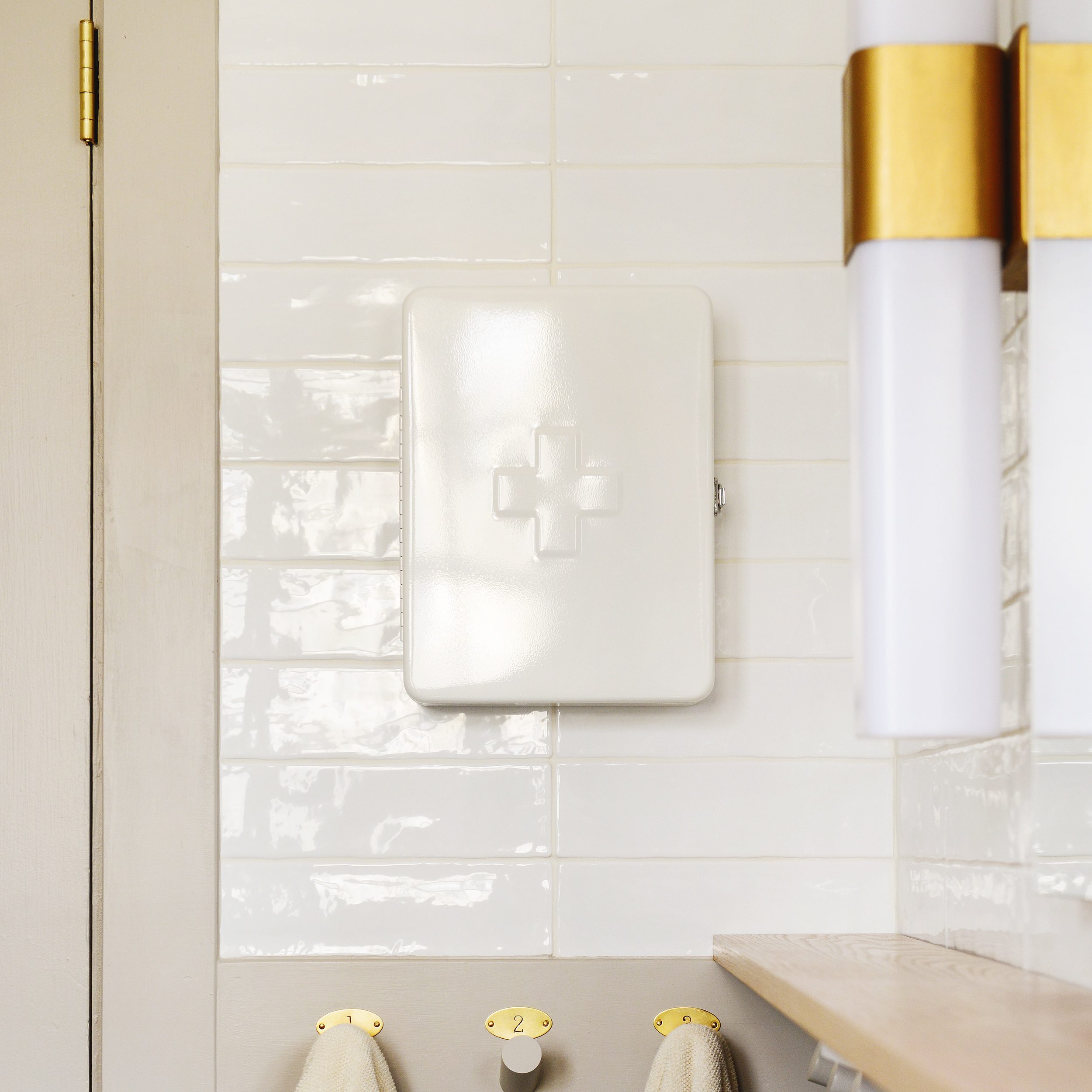 first aid cabinet hanging on a bathroom wall | via Yellow Brick Home