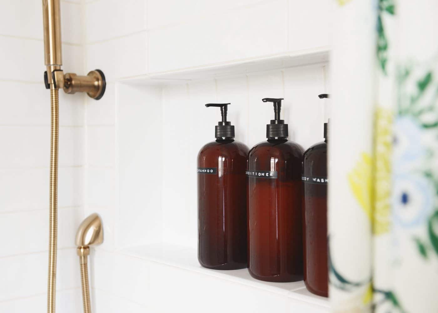 Soap pumps in a shower with black labels | via Yellow Brick Home