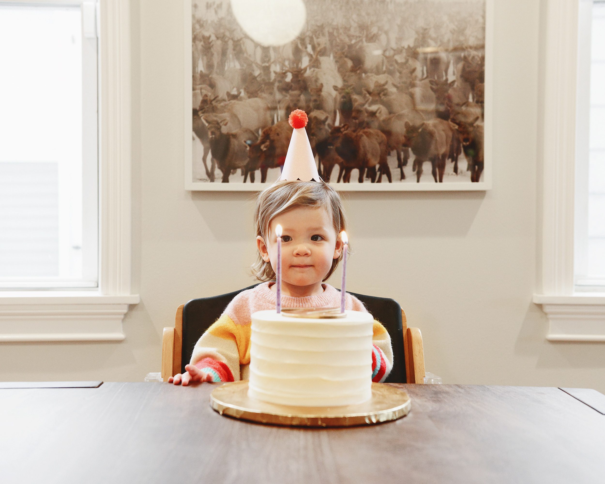 Lucy is 2! Our sweet girl with a simple birthday cake and 2 candles | via Yellow Brick Home