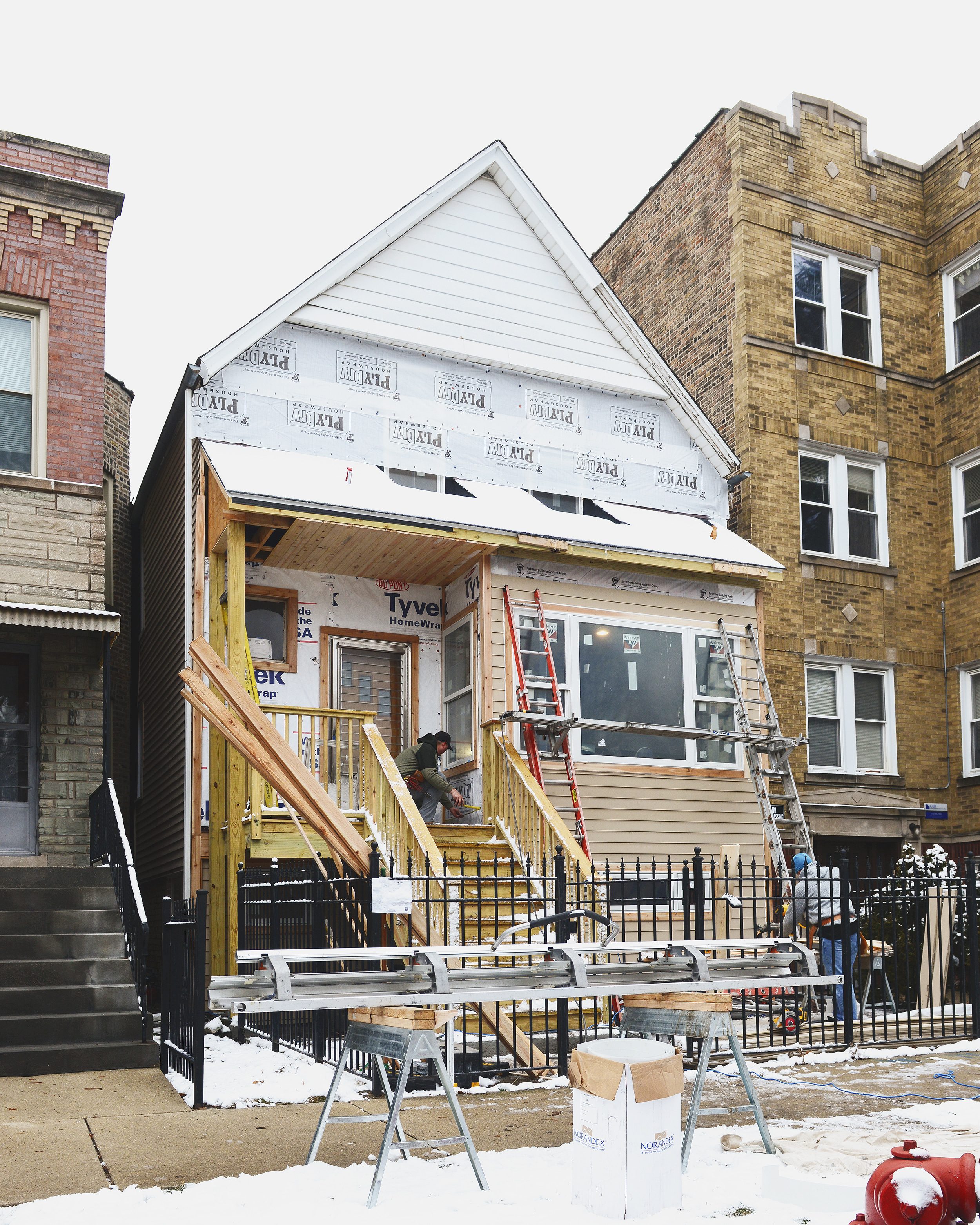 A Chicago two flat in the process of having new siding installed // via Yellow Brick Home