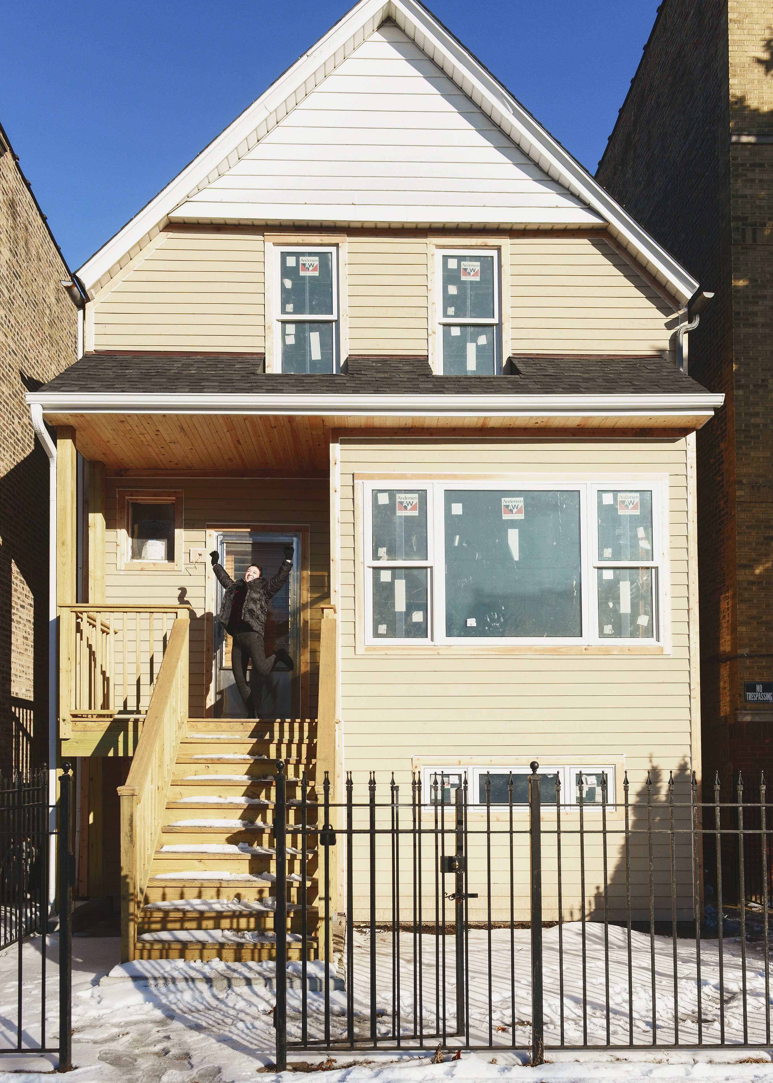 The finished exterior of a Chicago two flat with new windows and siding // via Yellow Brick Home