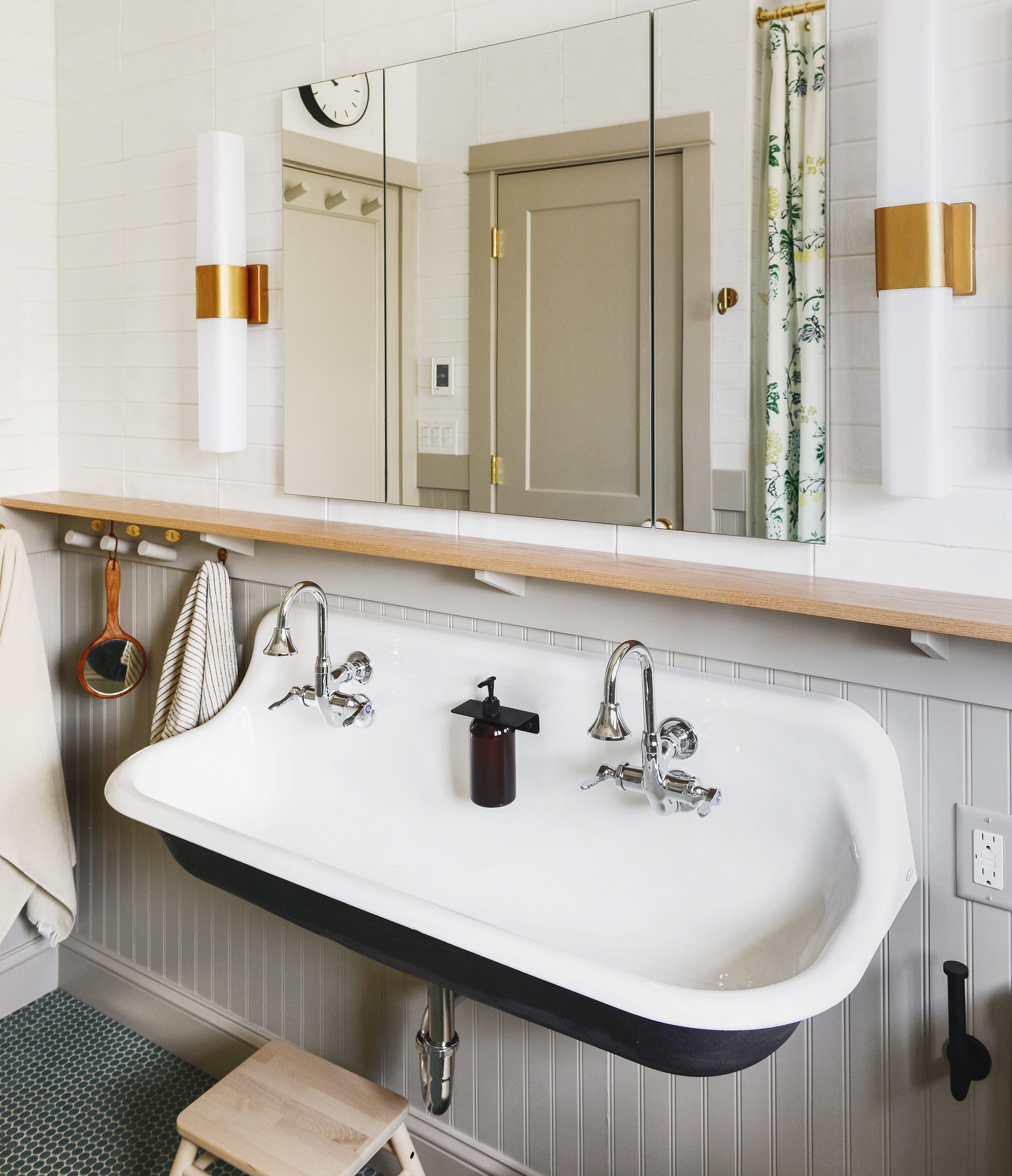 Our neutral bathroom with Kohler Brockway sink and large medicine cabinet, brass sconces and beadboard wall treatment | via Yellow Brick Home