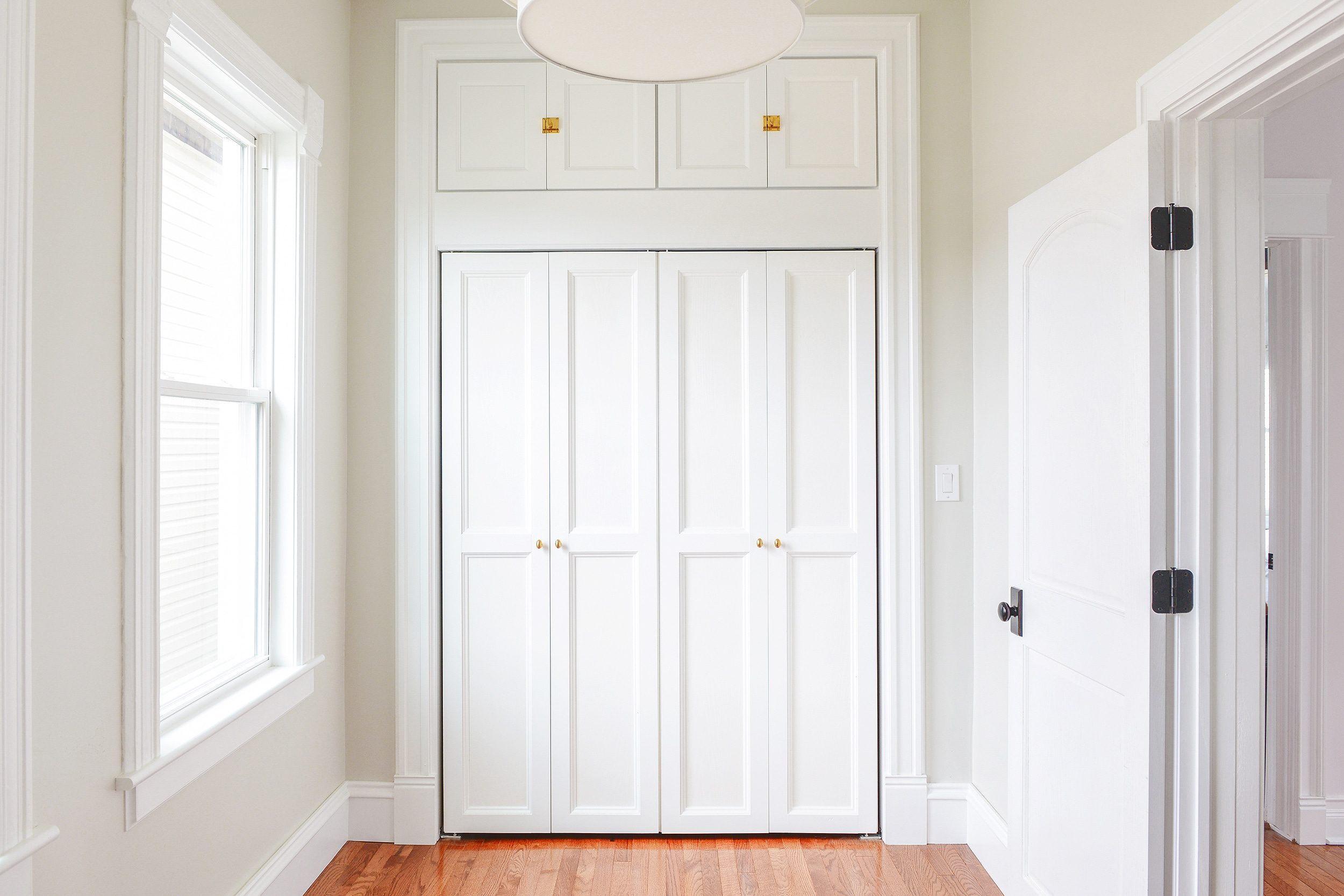 Bi-fold doors with DIY trim to make them more substantial! | via Yellow Brick Home