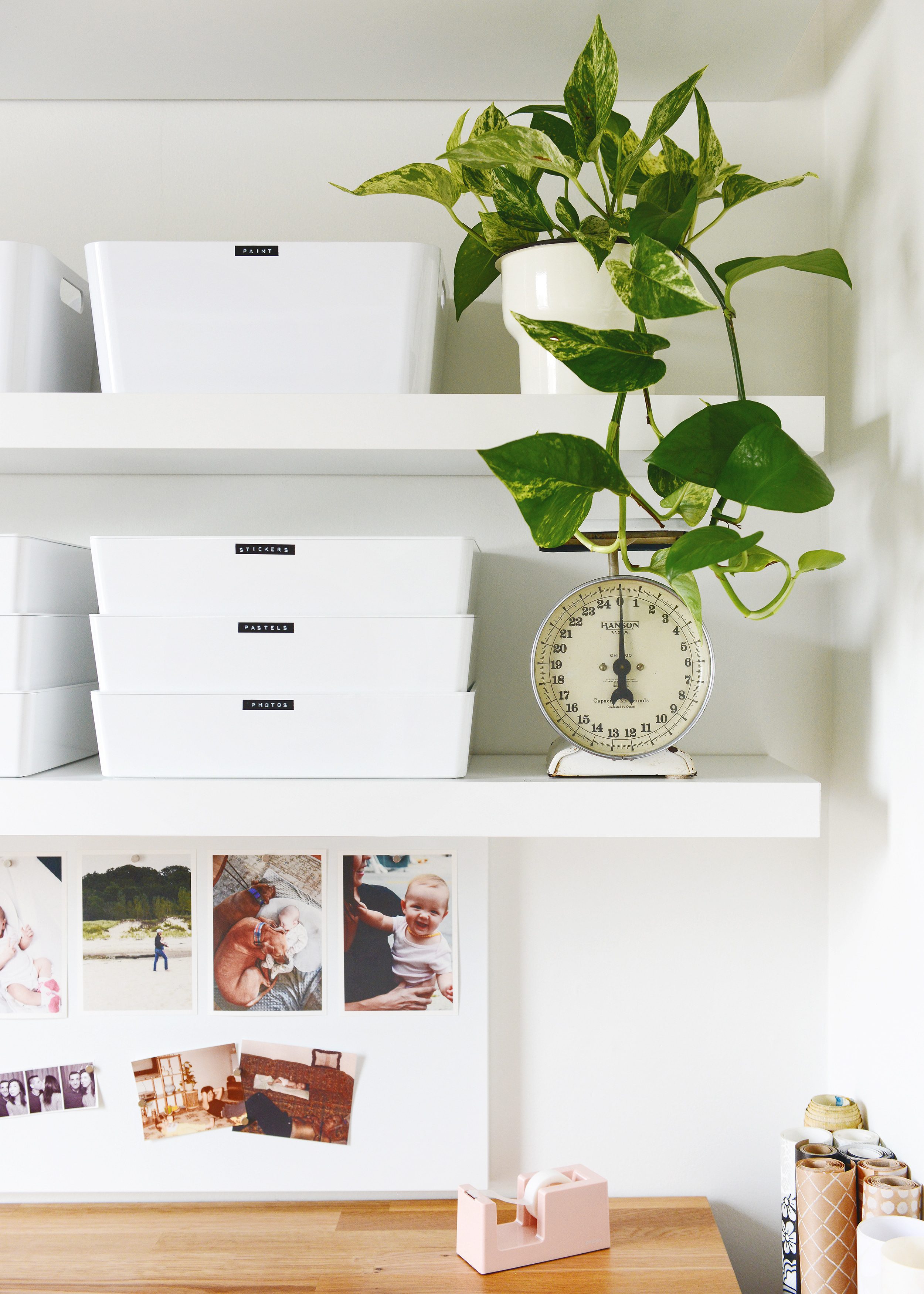 An organized craft room with floating white IKEA LACK shelves with plants and storage! via Yellow Brick Home