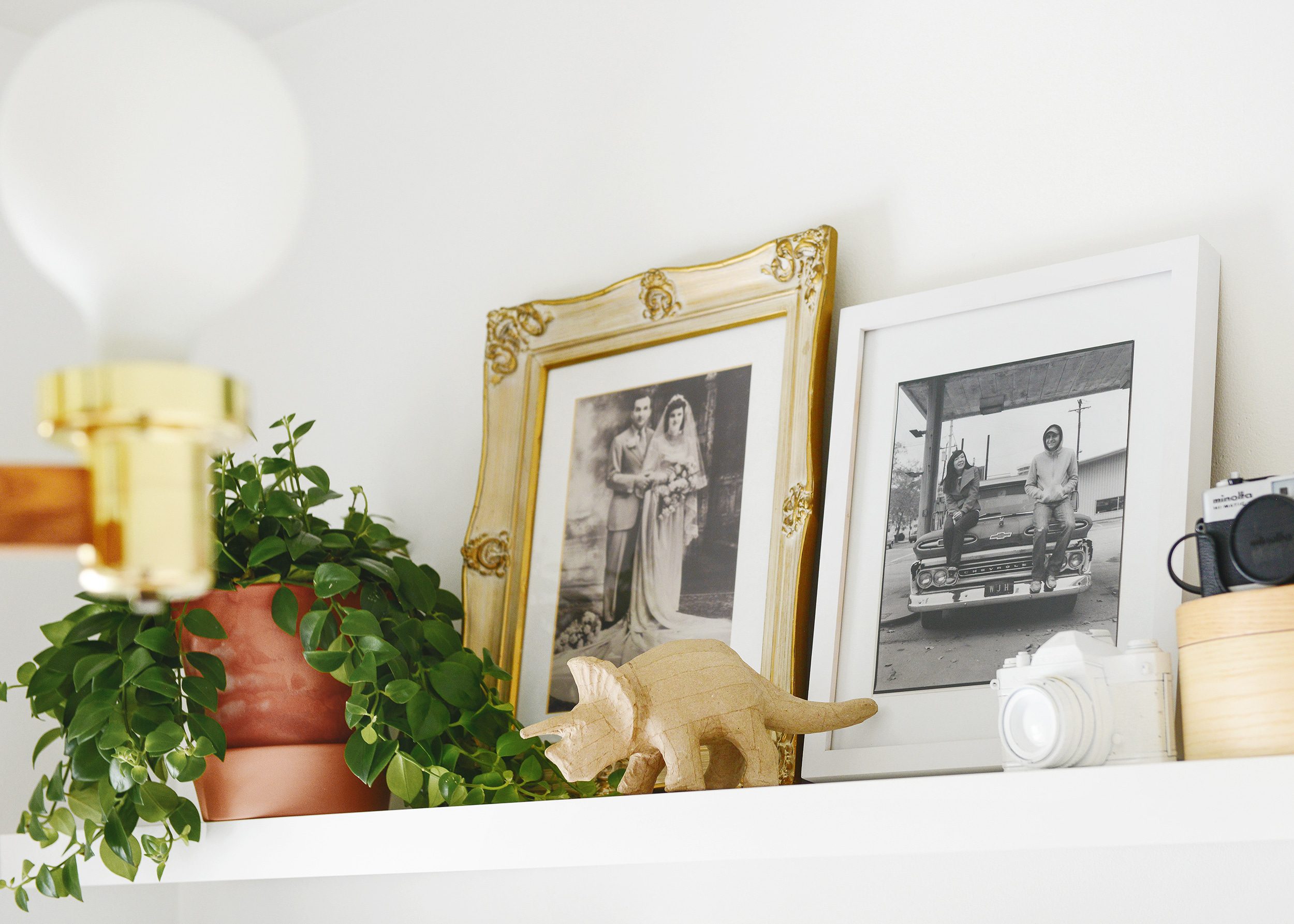 Family photos sit on the top shelf of our organized craft room | via Yellow Brick Home