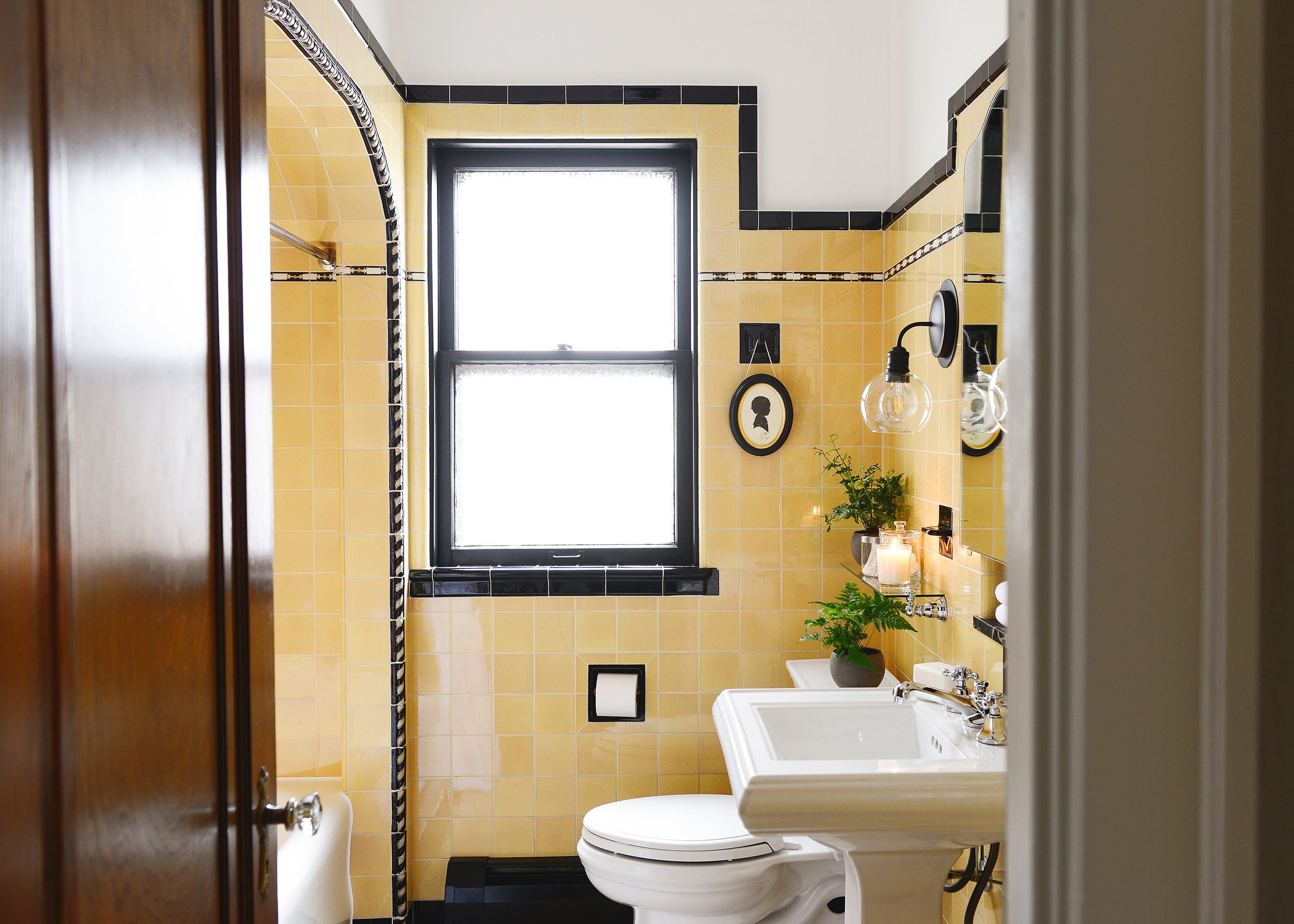 Silhouette of a child in a bathroom with vintage yellow tile | round-up of 19 works of art that would look good in a bathroom, via Yellow Brick Home