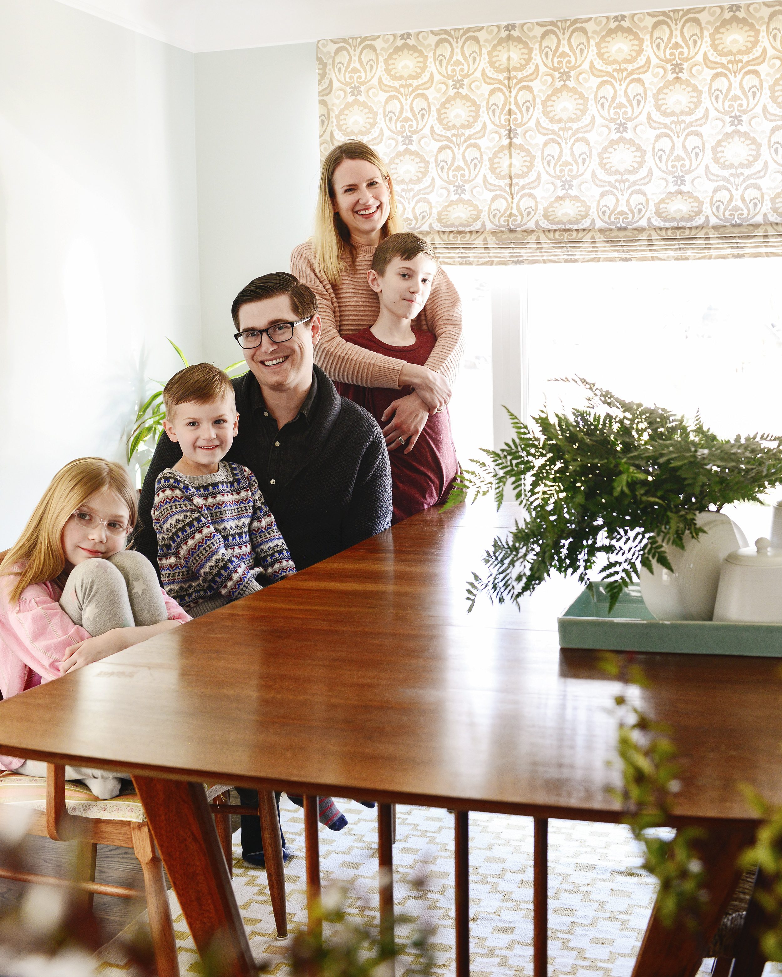 Family in a dining room with a Tailored Roman shade from Bali Blinds | via Yellow Brick Home