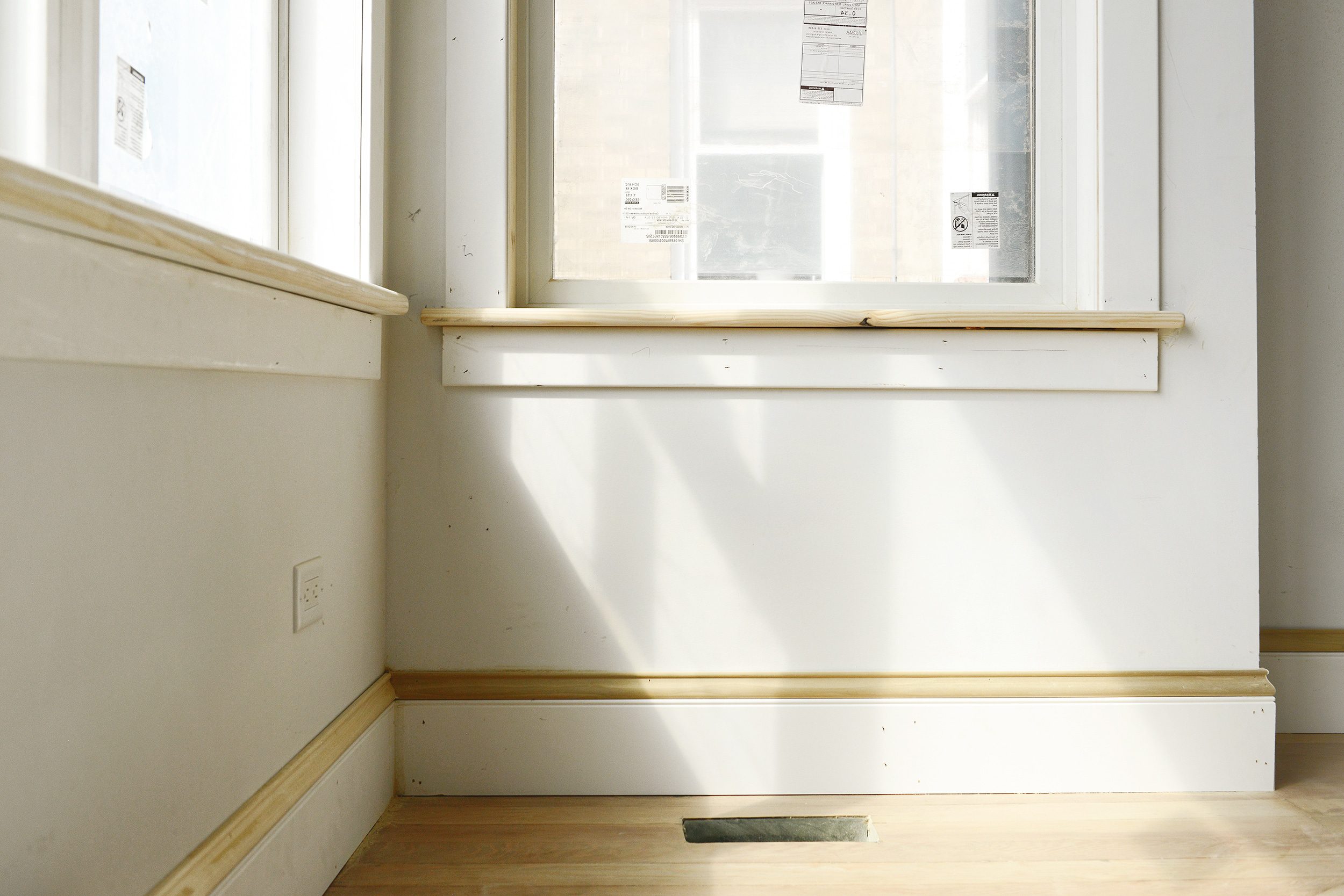 A close up of the window sills and baseboards in our bay window | via Yellow Brick Home