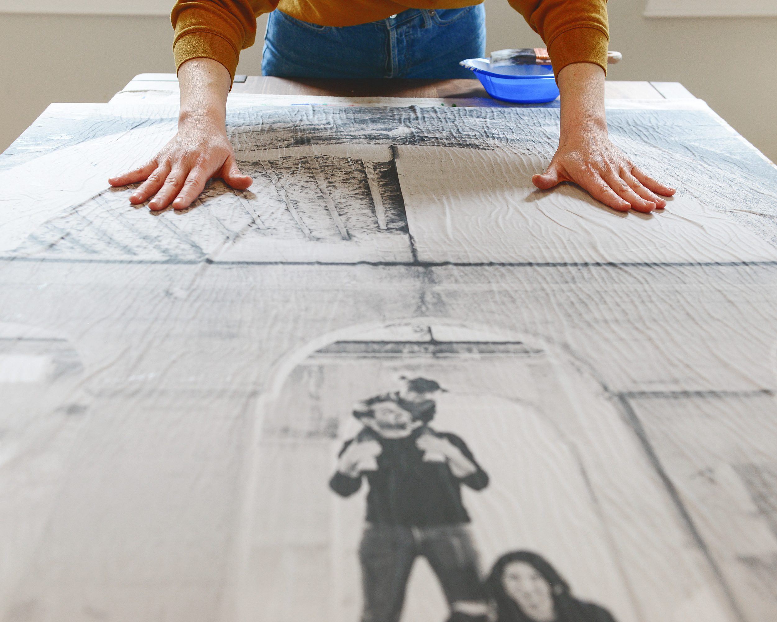Smoothing our engineer print that we Mod Podged onto canvas | DIY engineer print art | via Yellow Brick Home