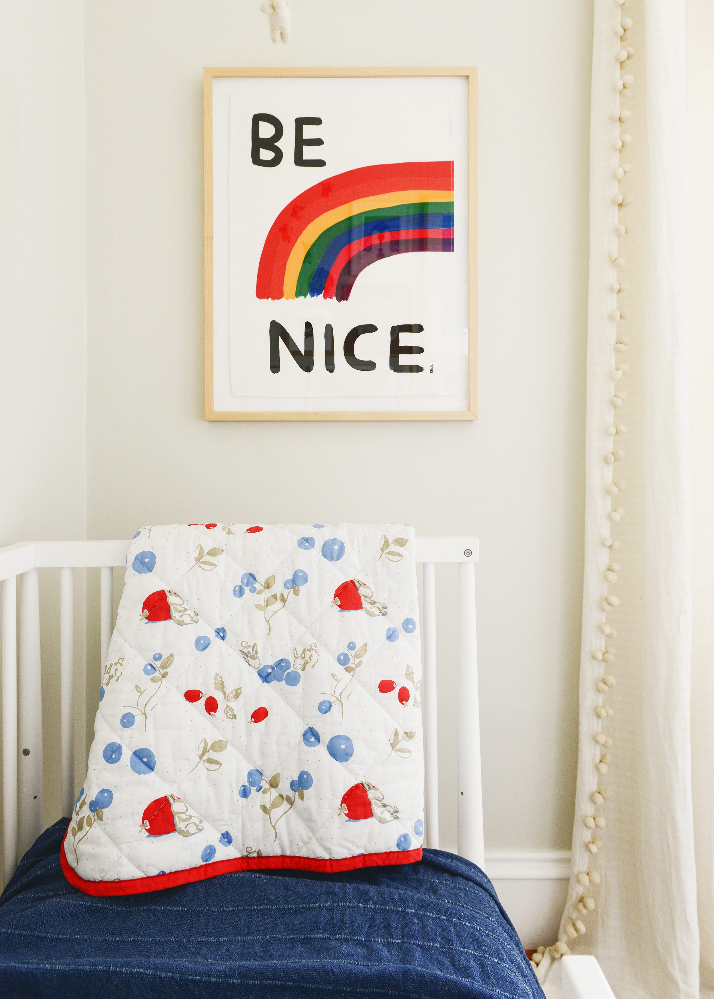 Detail shot of bedding on a crib with a toddler rail, IKEA bedding | via Yellow Brick Home