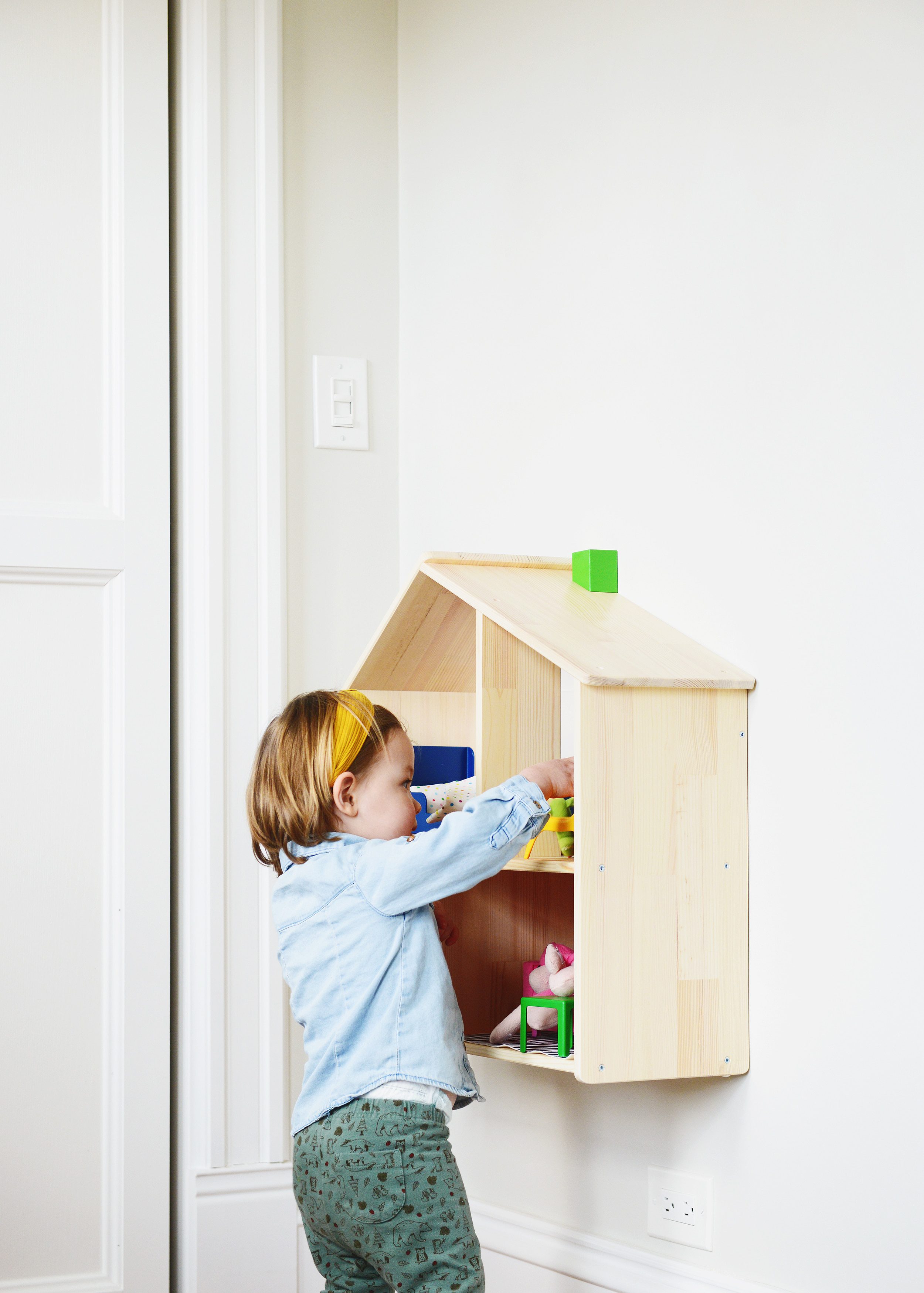Lucy playing with her IKEA doll house | via Yellow Brick Home