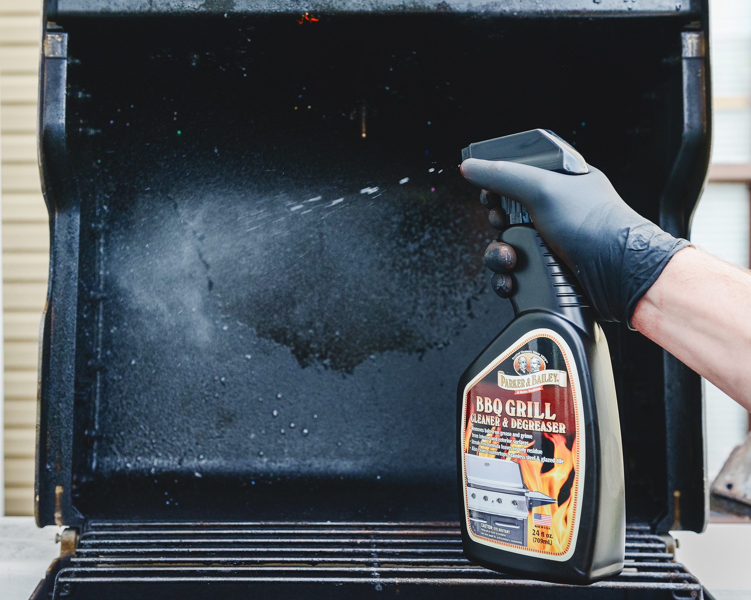 BBQ grill cleaning spray is used to degrease the inside of a weber gas grill // via yellow brick home