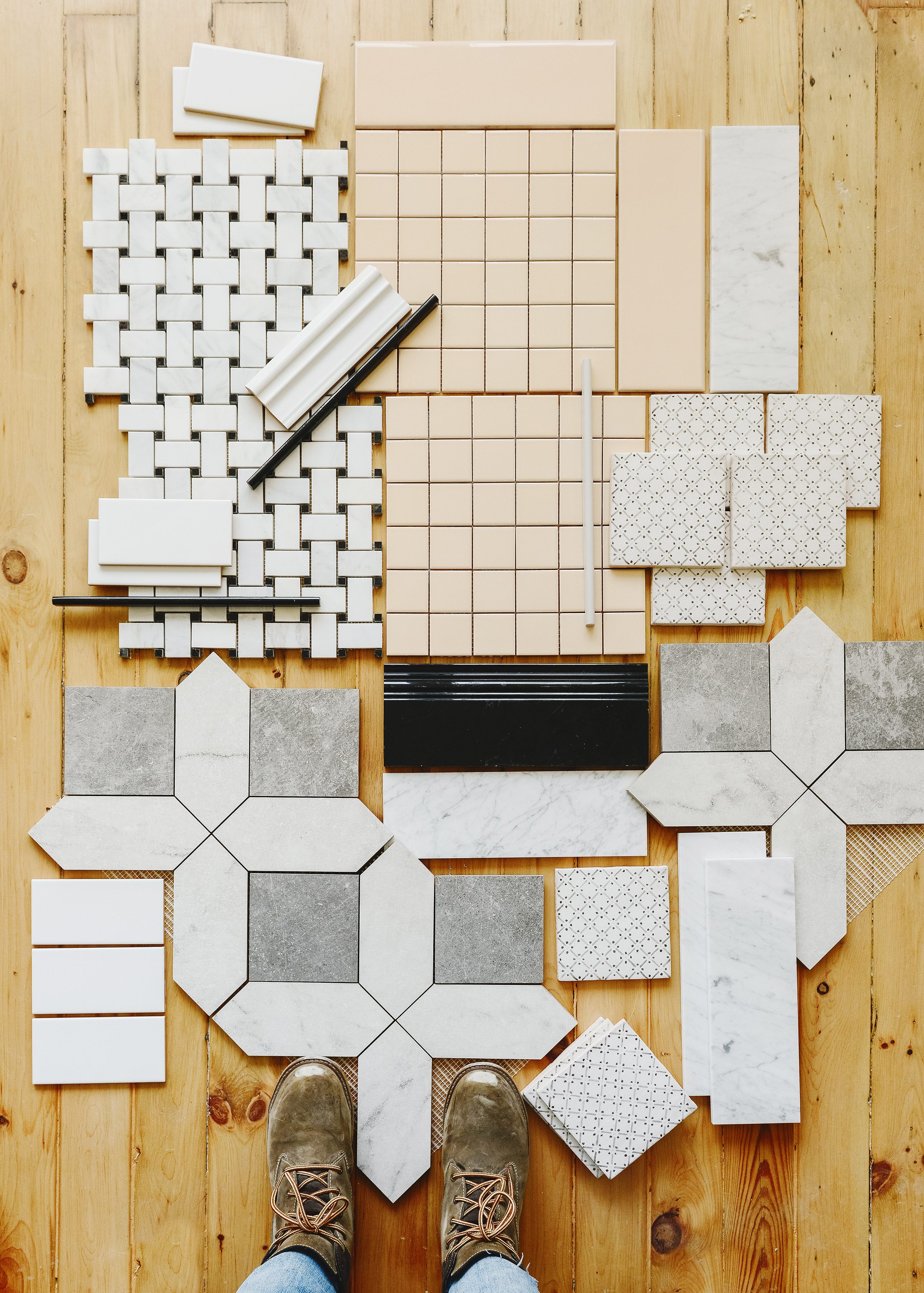A flat lay of all the tile to be used in Yellow Brick Home's Two Flat renovation, Kim's work boots