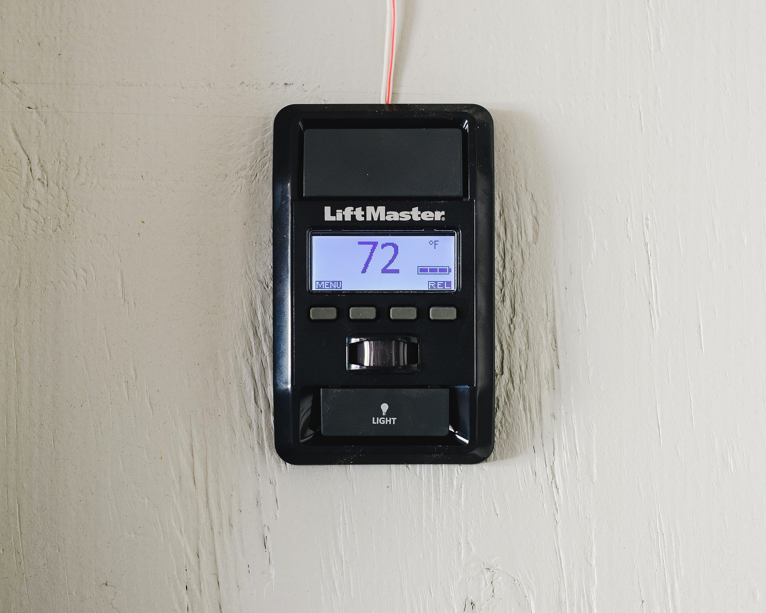 A Liftmaster Smart Control Panel installed on a white garage wall // via yellow brick home 