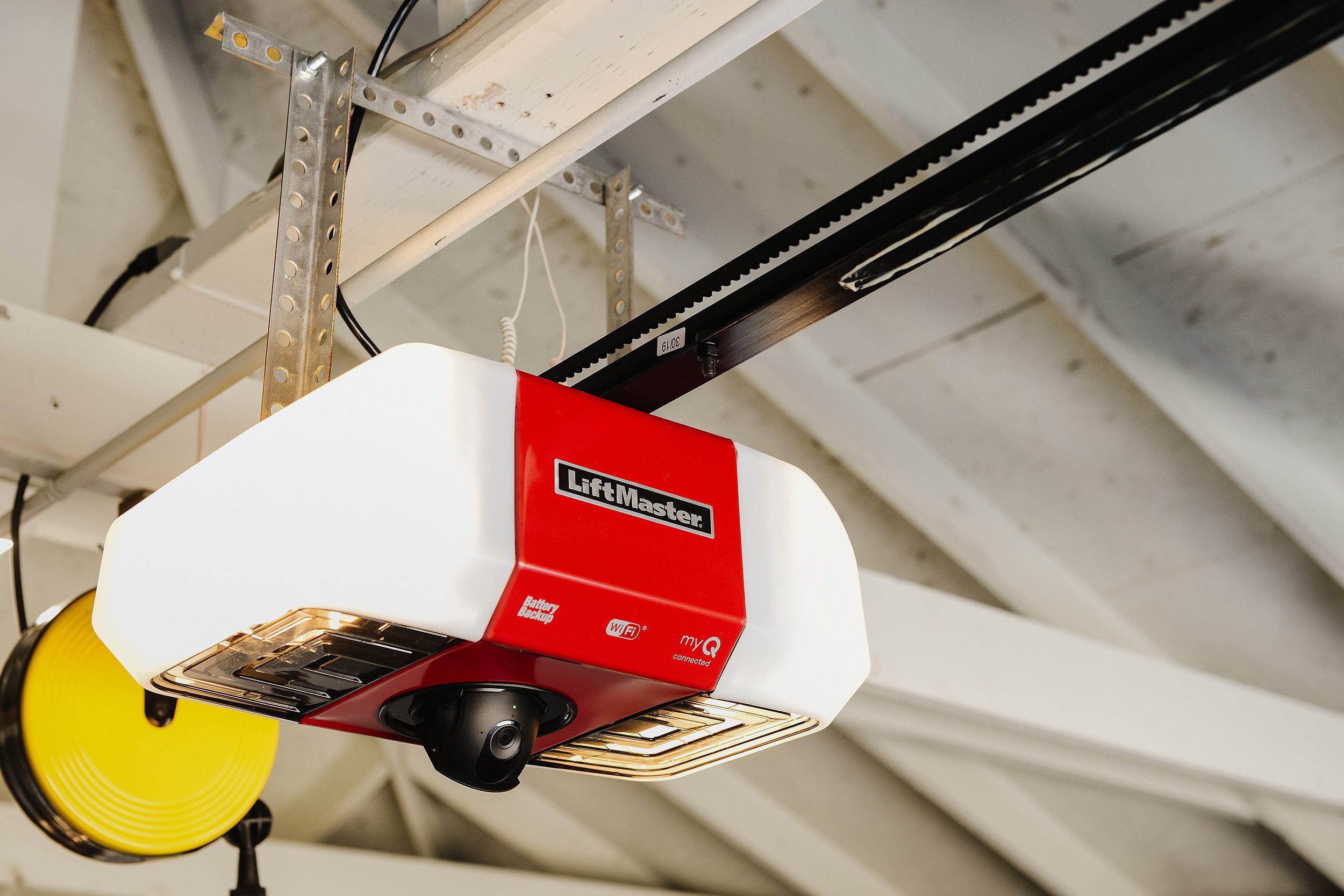 A liftmaster secure view garage door opener in an all white garage // via yellow brick home 