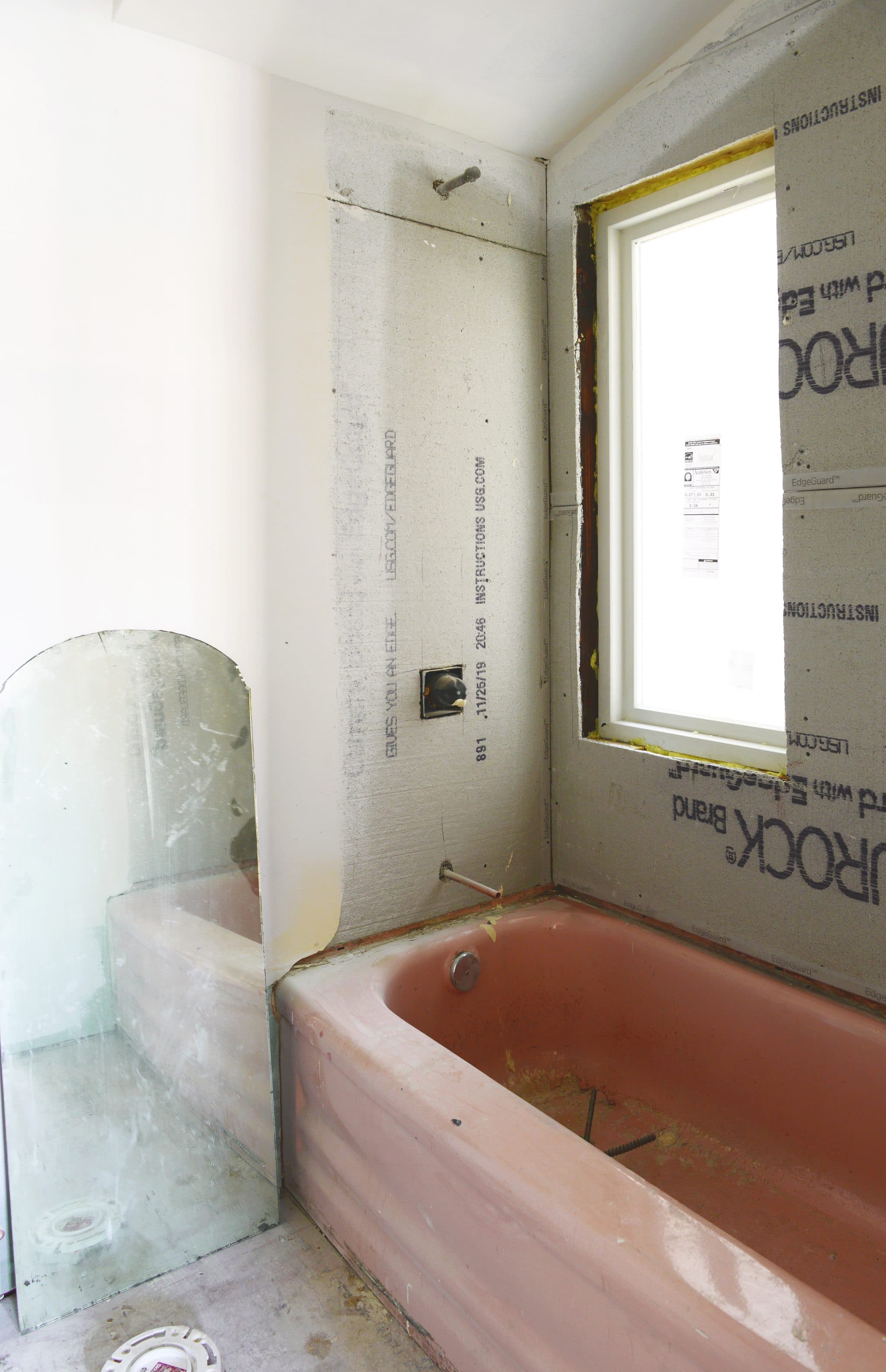 A primed bathroom sits ready for tile and finishing touches // via yellow brick home