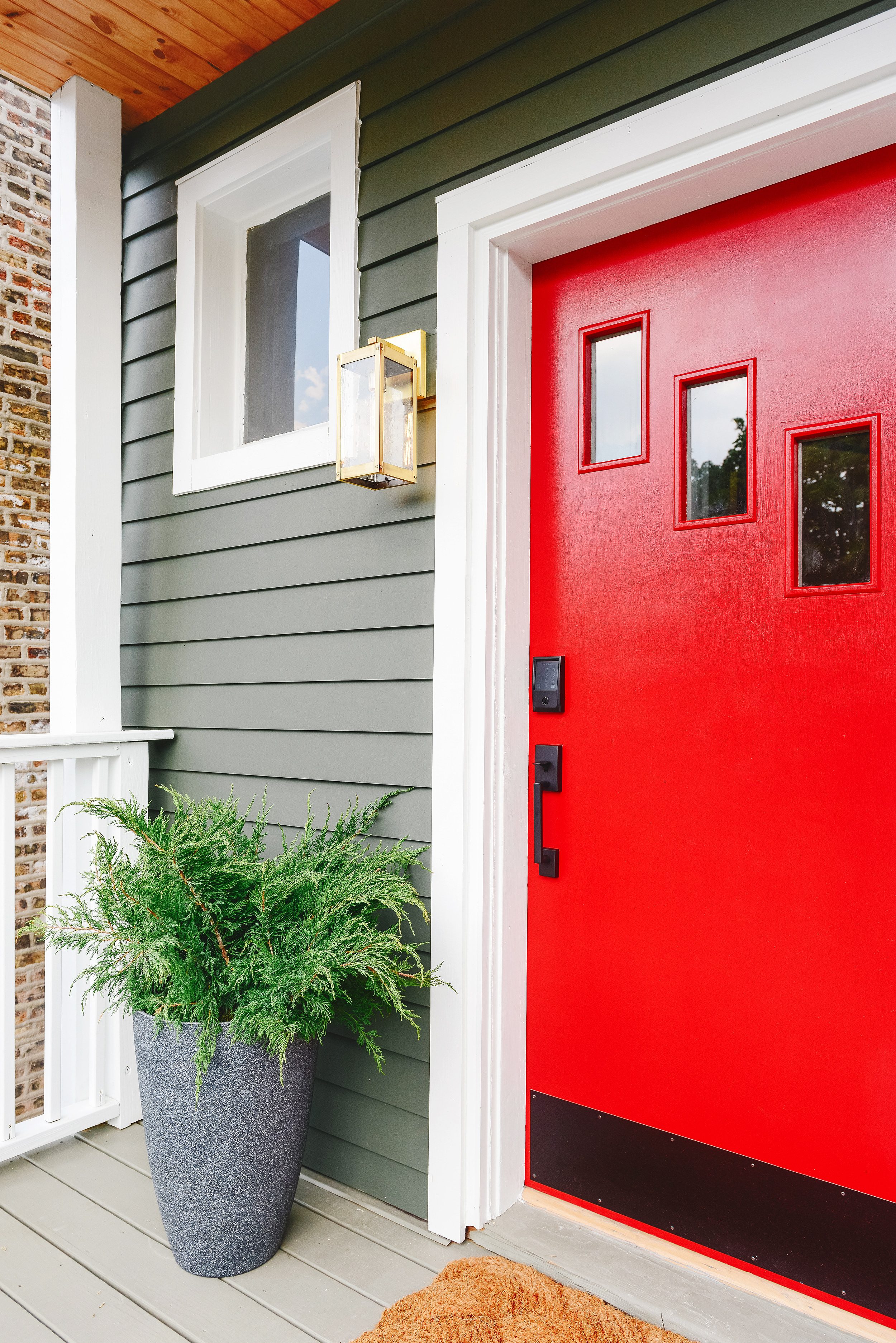 Detail of front porch showing the Schlage Encode smart lock on a bright red front door | via Yellow Brick Home