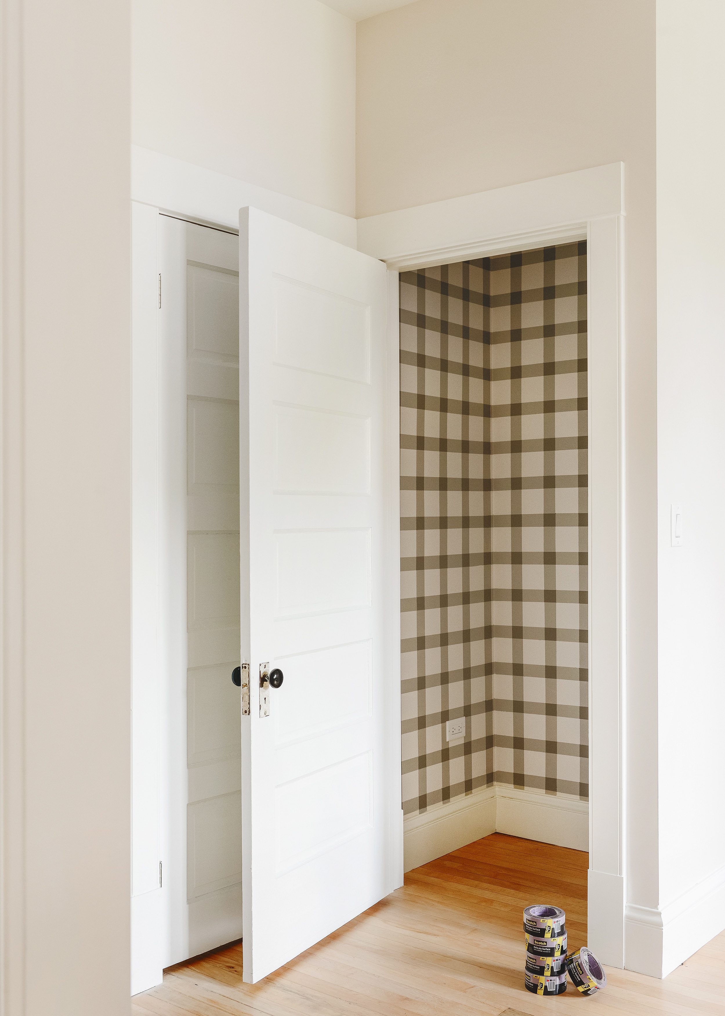 A view of the pantry closet showcasing a painted DIY plaid pattern | via Yellow Brick Home
