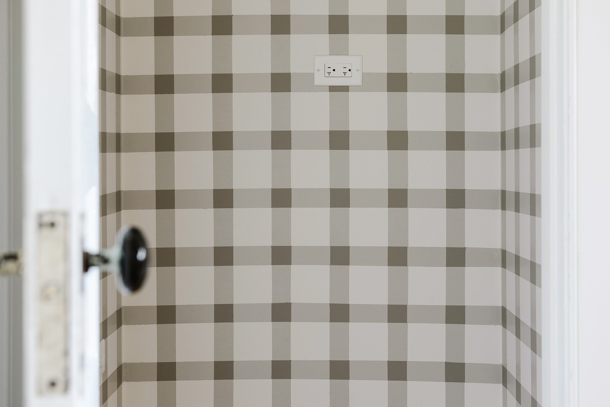 A detailed view of a DIY plaid paint project inside a pantry closet | via Yellow Brick Home