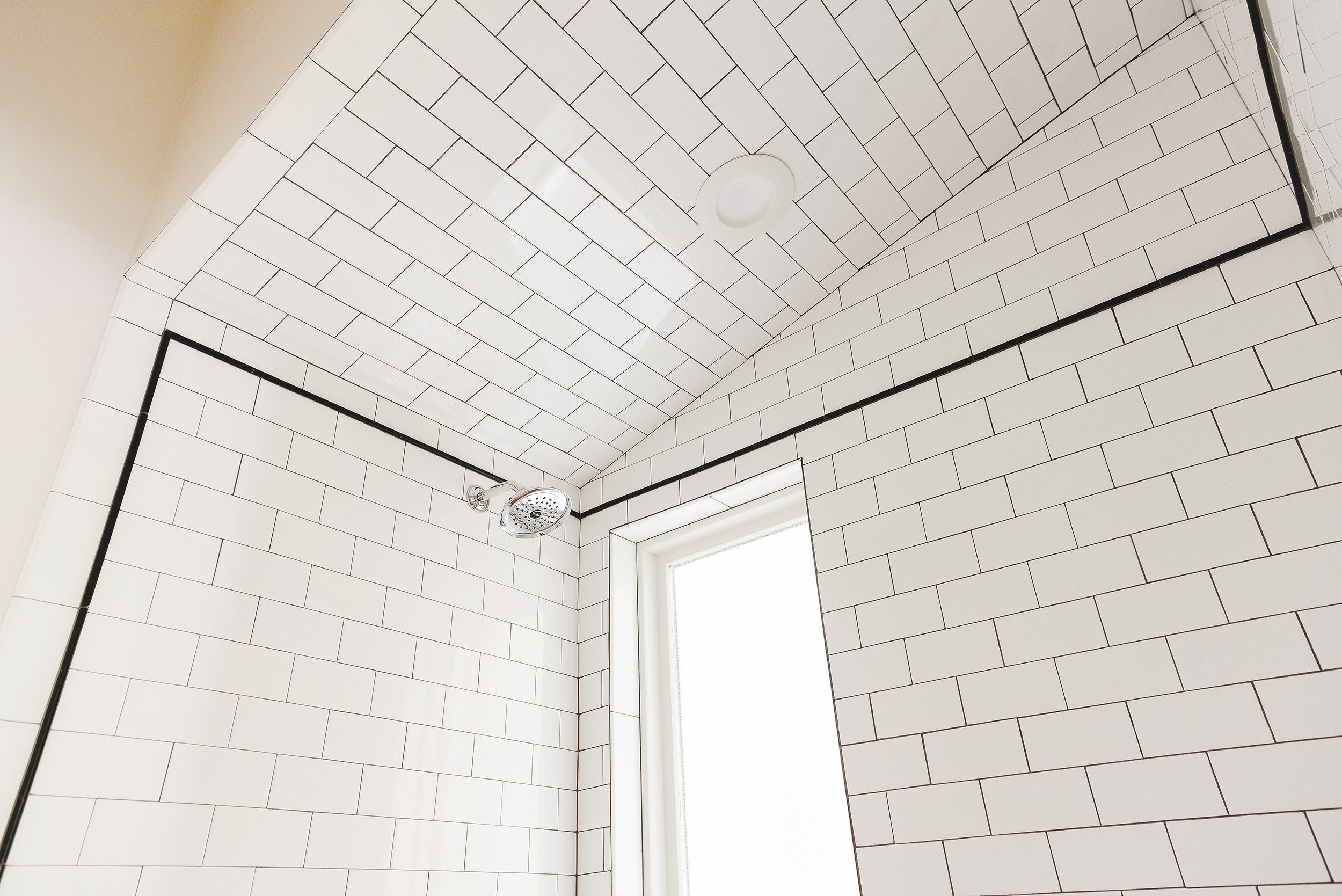 detail of tiling a sloped ceiling with subway tile | via Yellow Brick Home