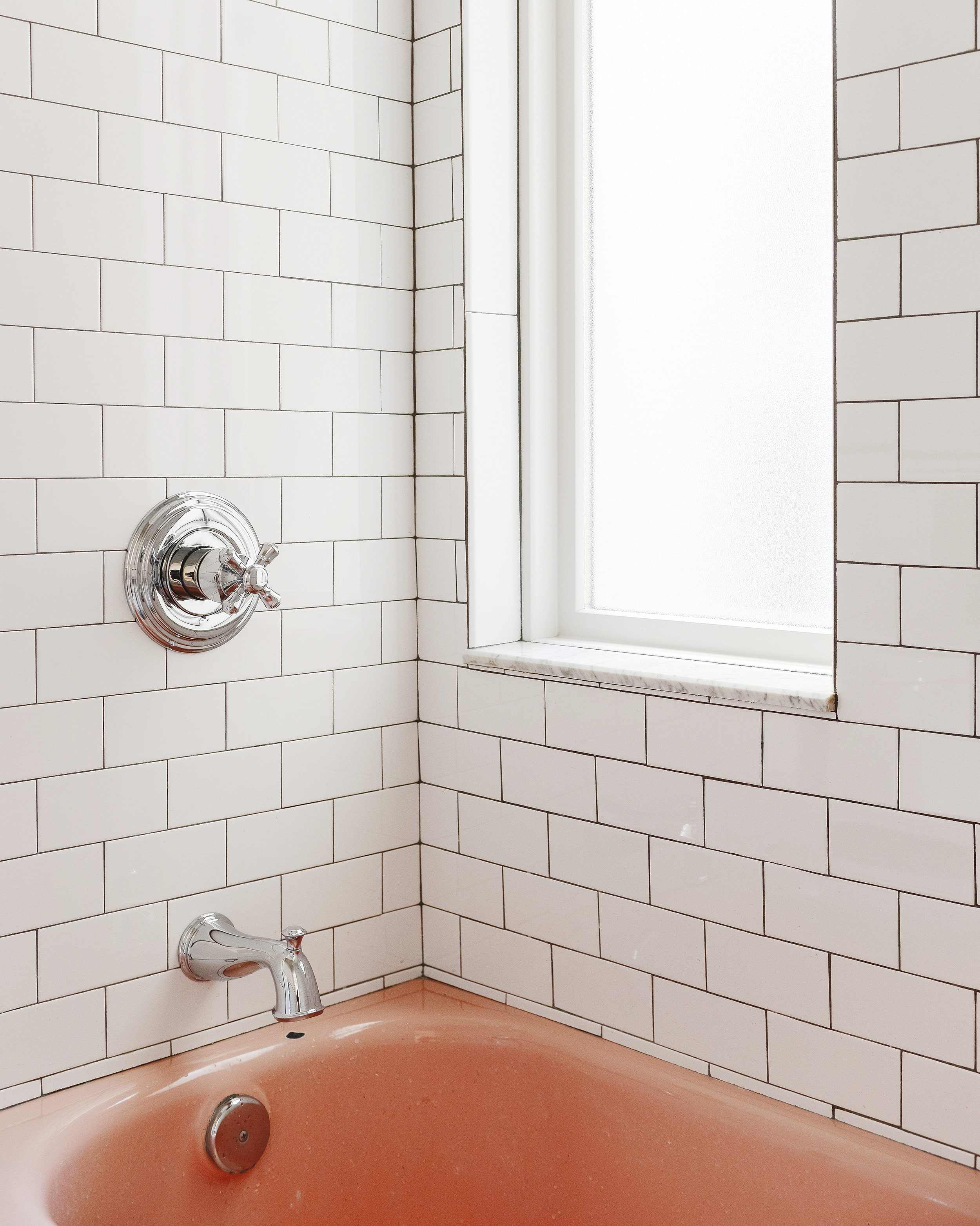 detail of subway tile with polished chrome Delta fixtures | via Yellow Brick Home