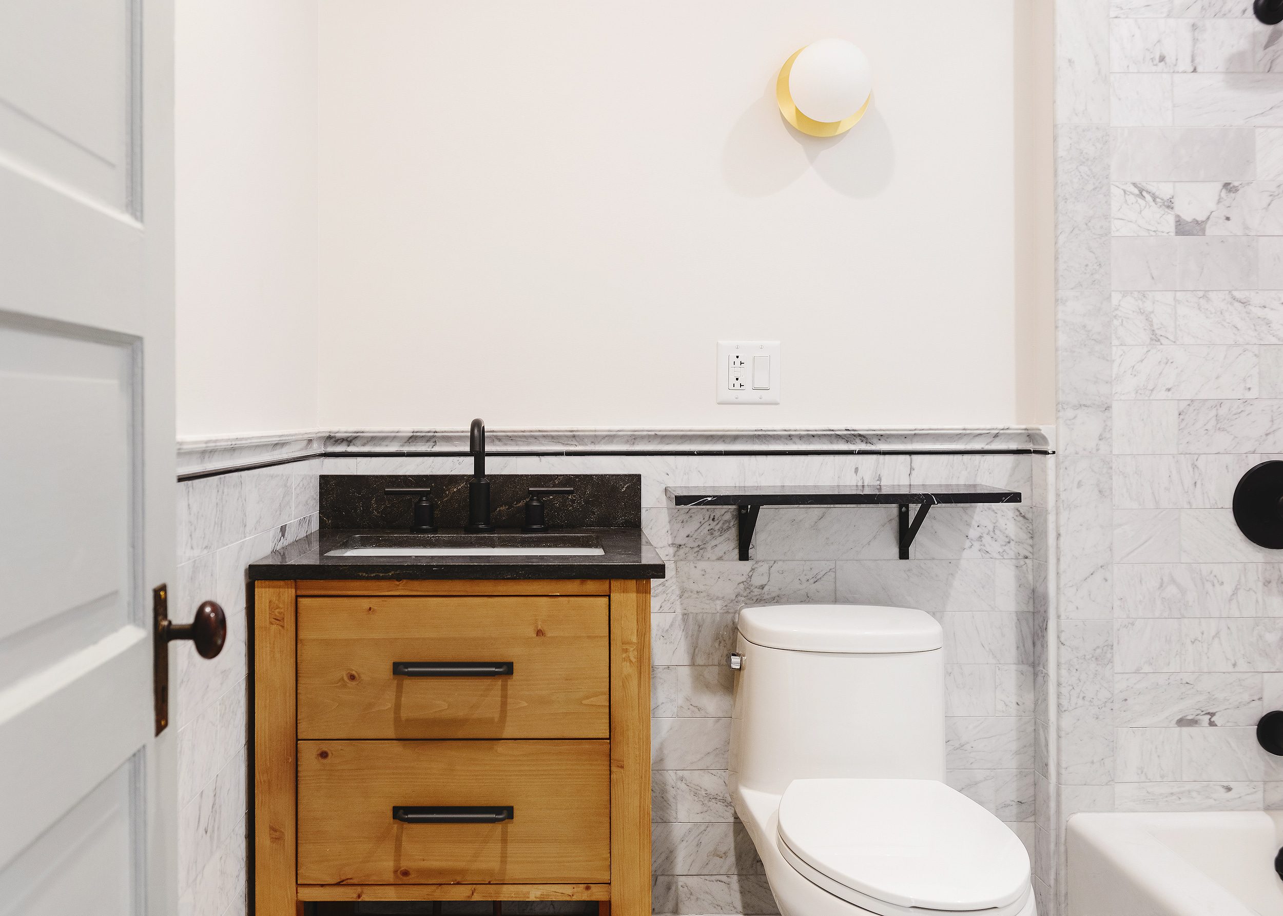 Our marble bathroom before the finishing touches | via Yellow Brick Home
