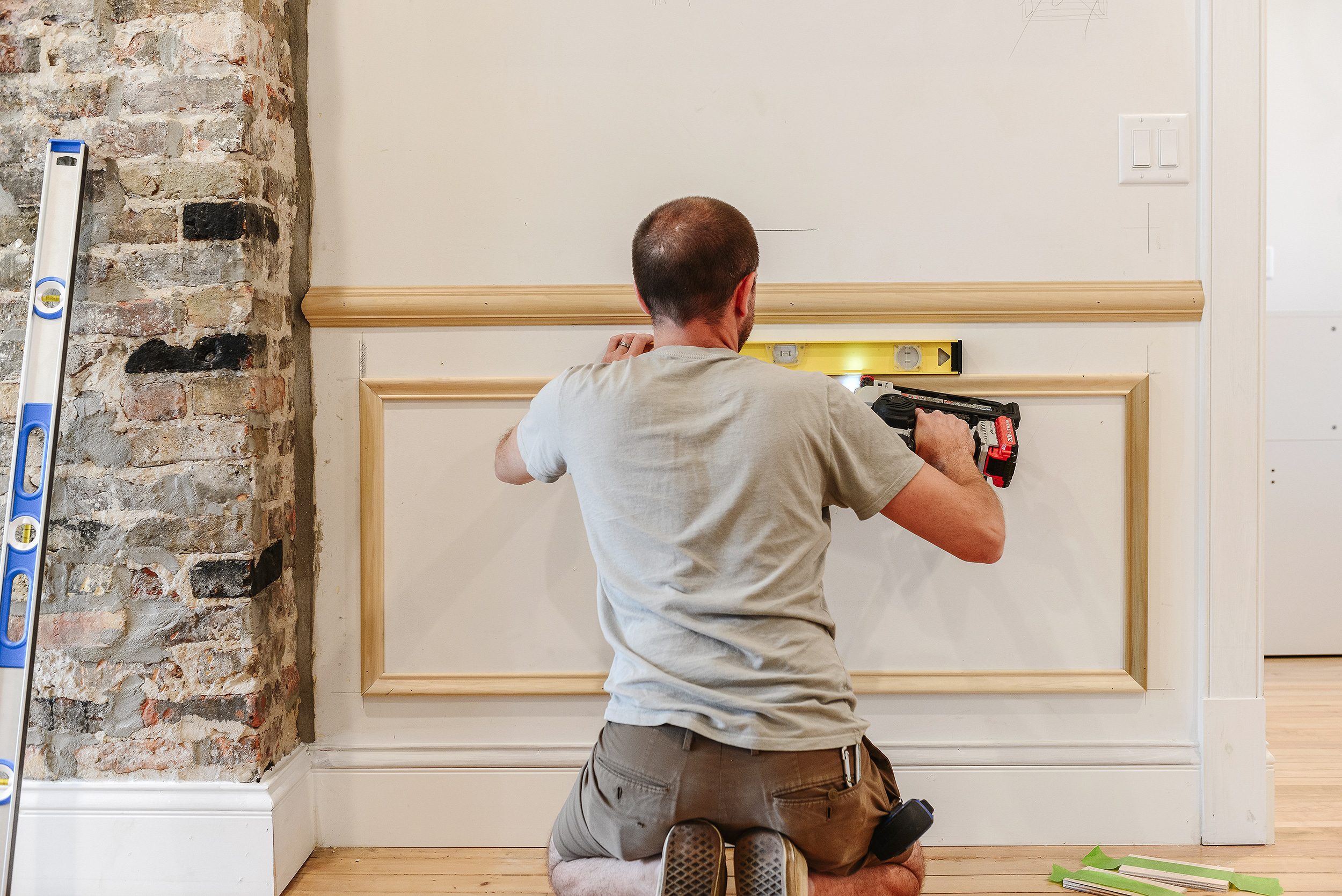 Installing panel molding in the dining room | via Yellow Brick Home