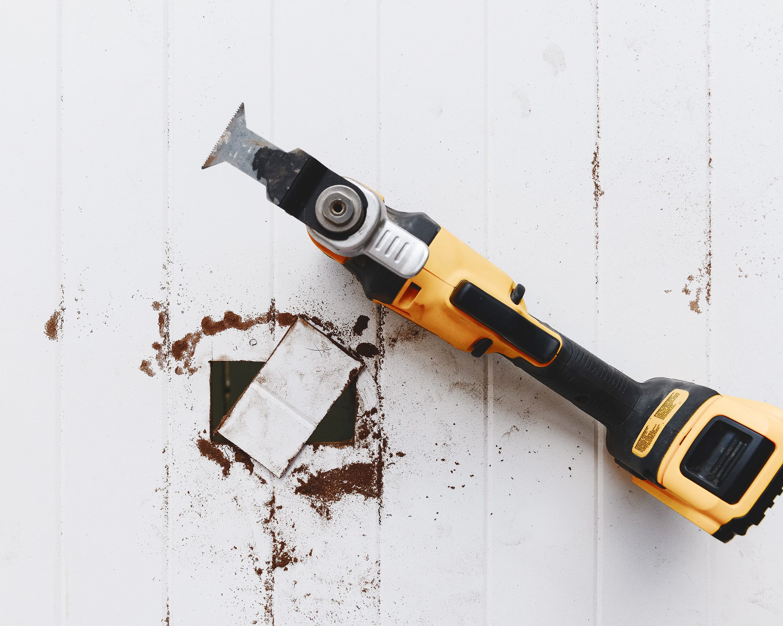 An oscillating tool is used to remove material from a beadboard panel for an electrical outlet. 
