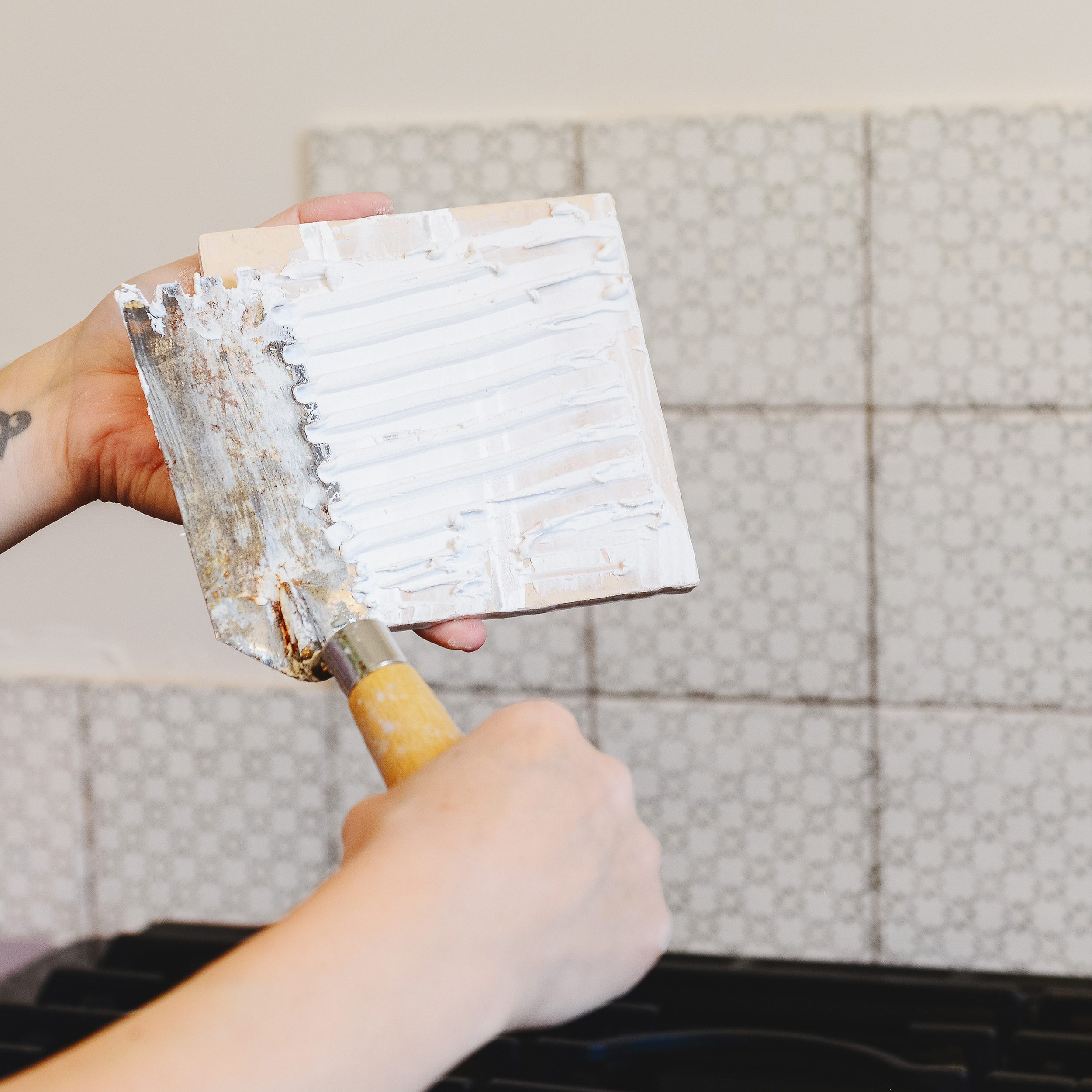 Back butter each individual tile in a tight space. via Yellow Brick Home x @thetileshop #ad