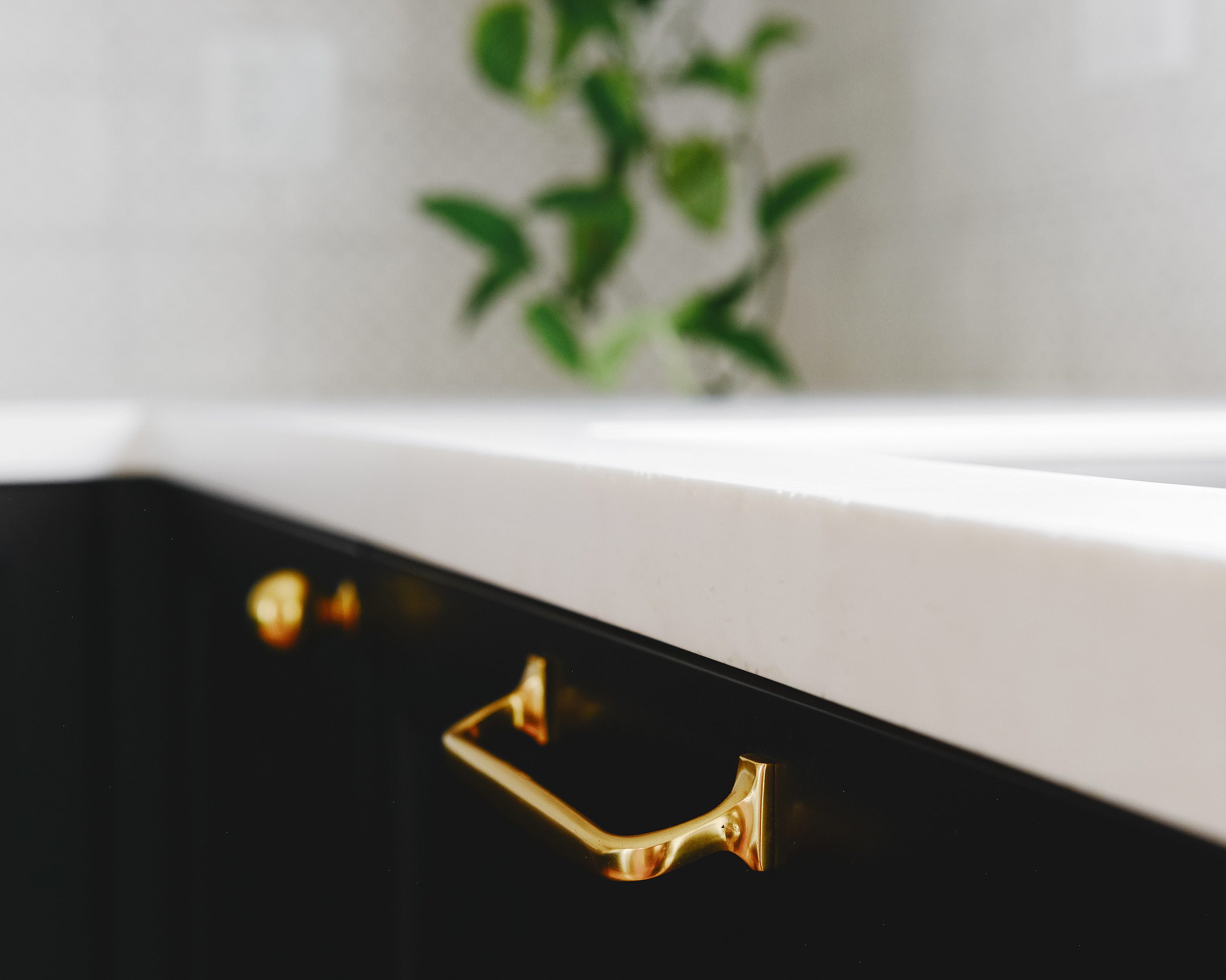 Close-up of Formica Bleached Concrete Everform countertops with brass pulls | via Yellow Brick Home