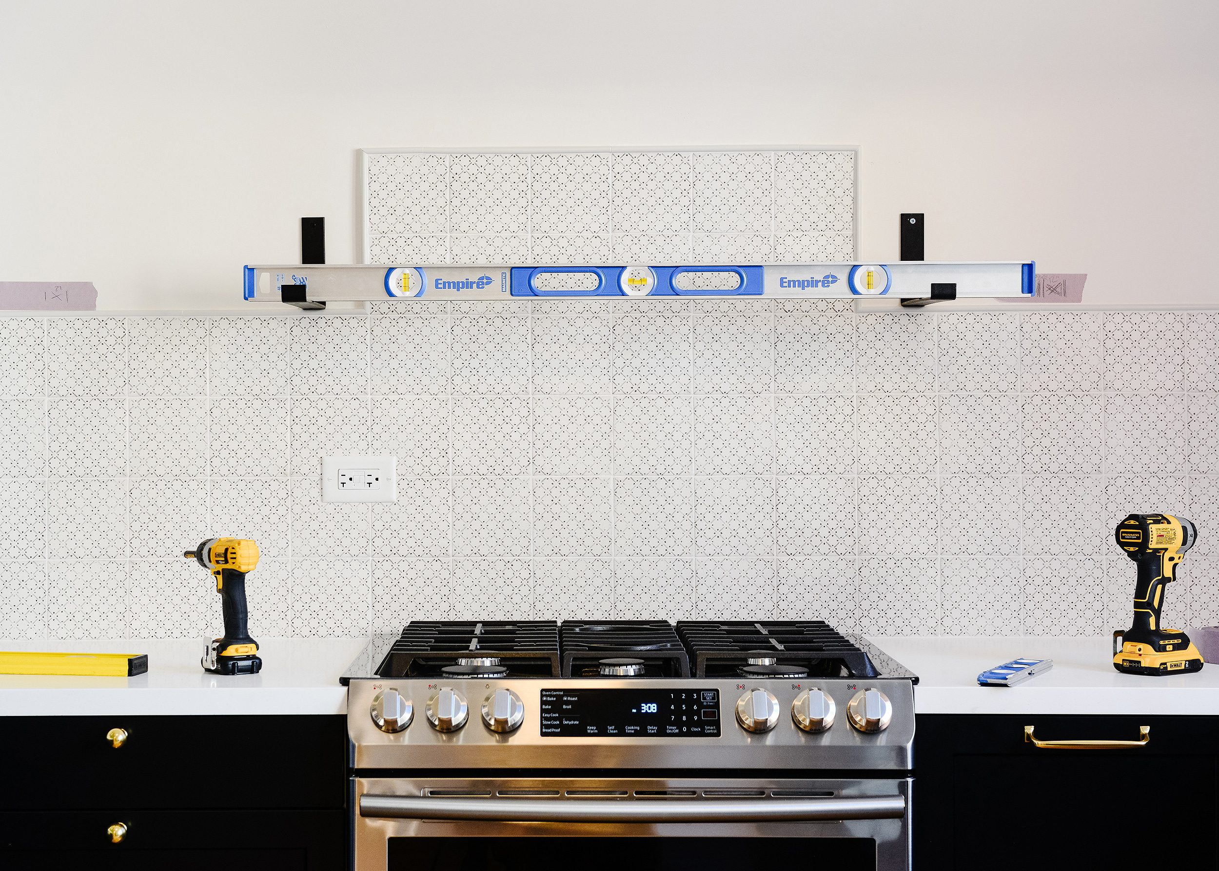 Leveling and securing metal brackets to the walls using toggle bolts for extra strength! via Yellow Brick Home