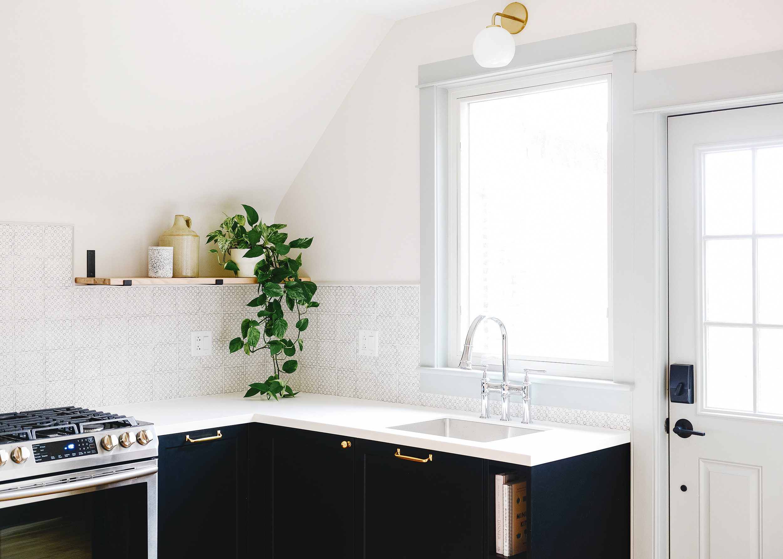 Formica countertops in Bleached Concrete with black cabinets | via Yellow Brick Home