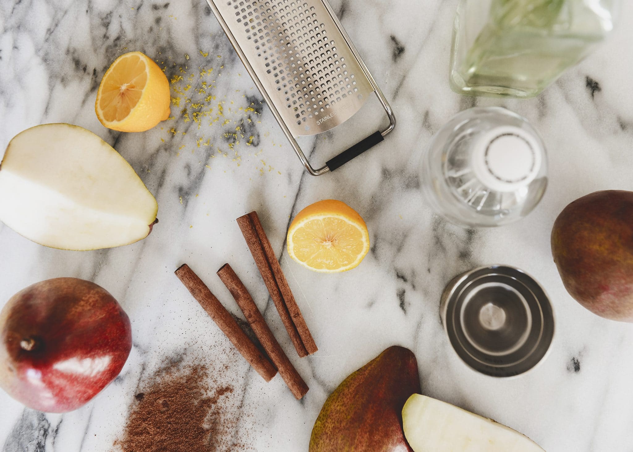 A flat lay of ingredients that make up a Festive Pear + Gin Cocktail with Infused Ice // via Yellow Brick Home