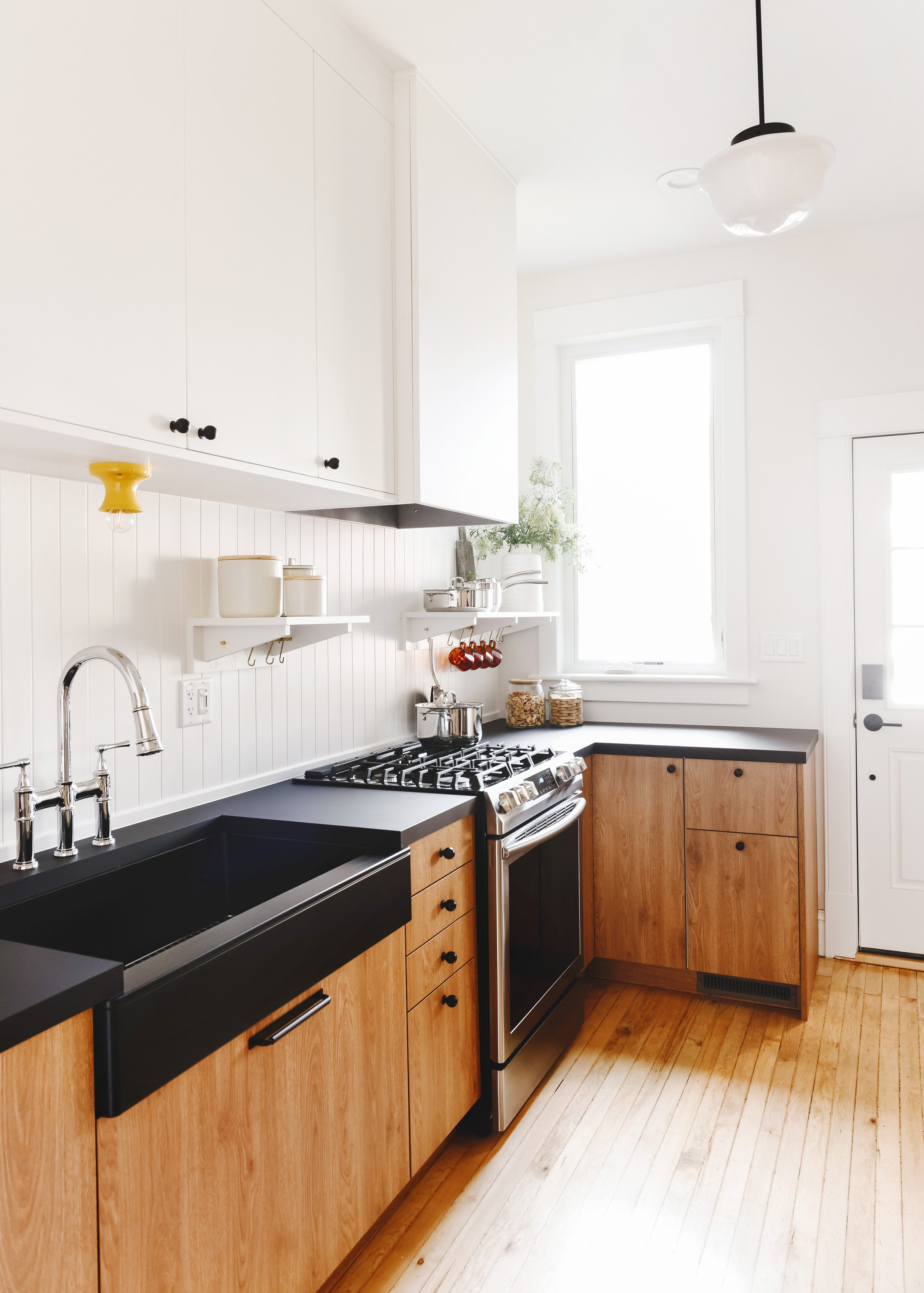 A compact but mighty wood + white kitchen | via Yellow Brick Home